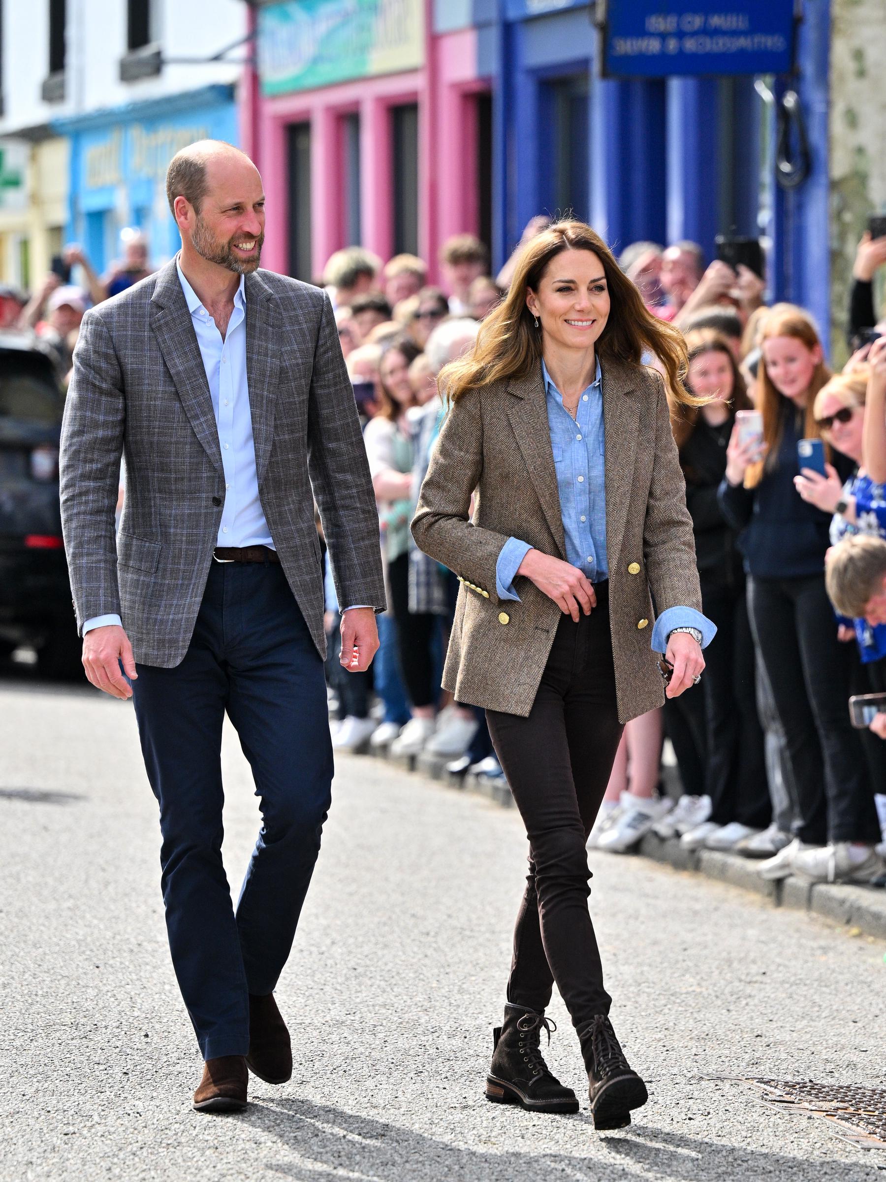 Prince William and Princess Catherine, known as the Duke and Duchess of Rothesay in Scotland, are warmly welcomed by locals as they walk through the vibrant streets of Tobermory during their visit to Aros Hall, a hub supporting community initiatives on the Isle of Mull.