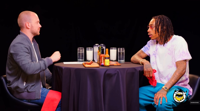 Sean Evans interviews Wiz Khalifa during an episode of "Hot Ones" in a video shared on July 26, 2018. | Source: YouTube/First We Feast