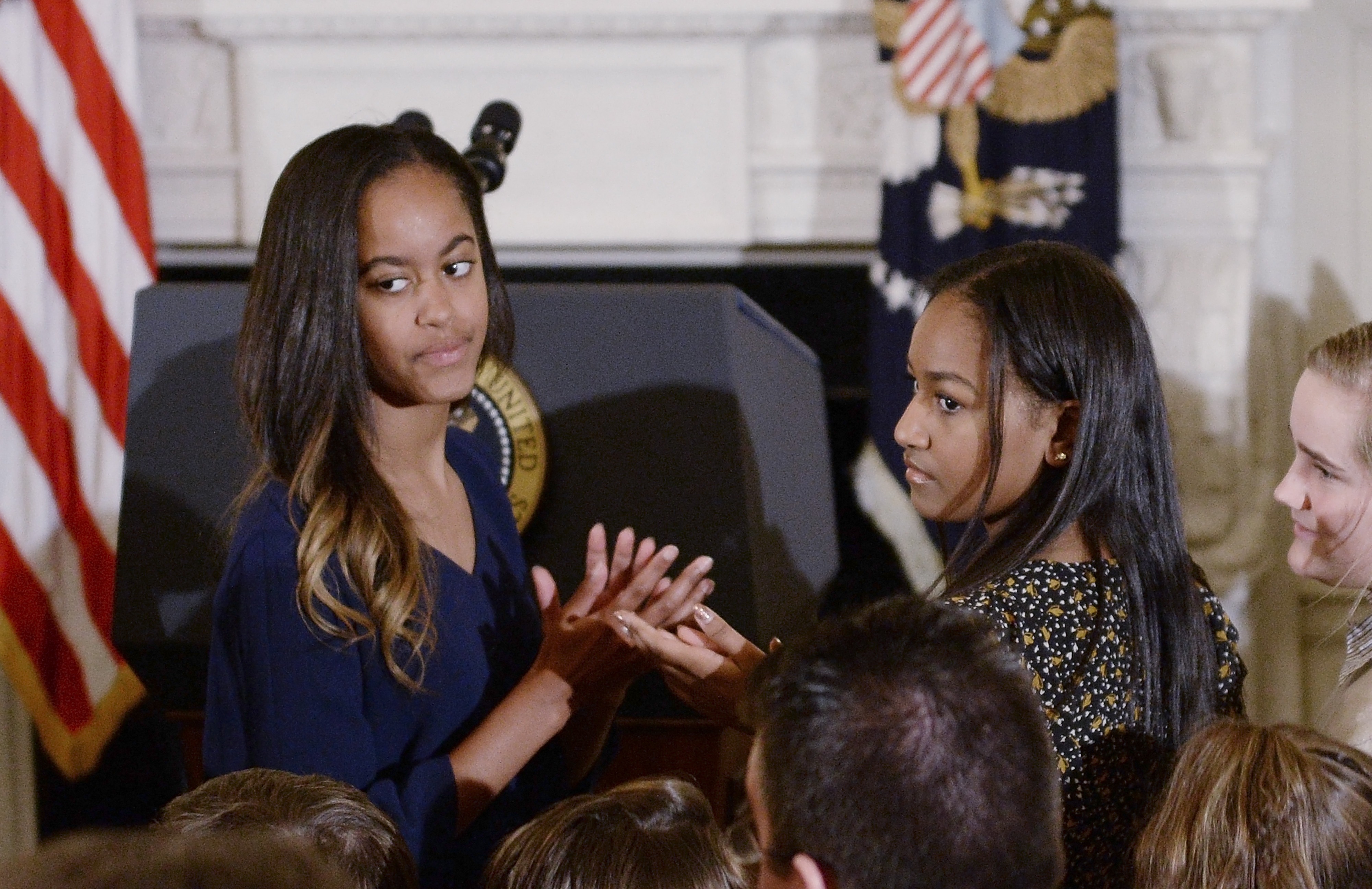 Malia and Sasha Obama at a ceremony presenting the Medal of Freedom to Vice-President Joe Biden in Washington, DC on January 12, 2017 | Source: Getty Images