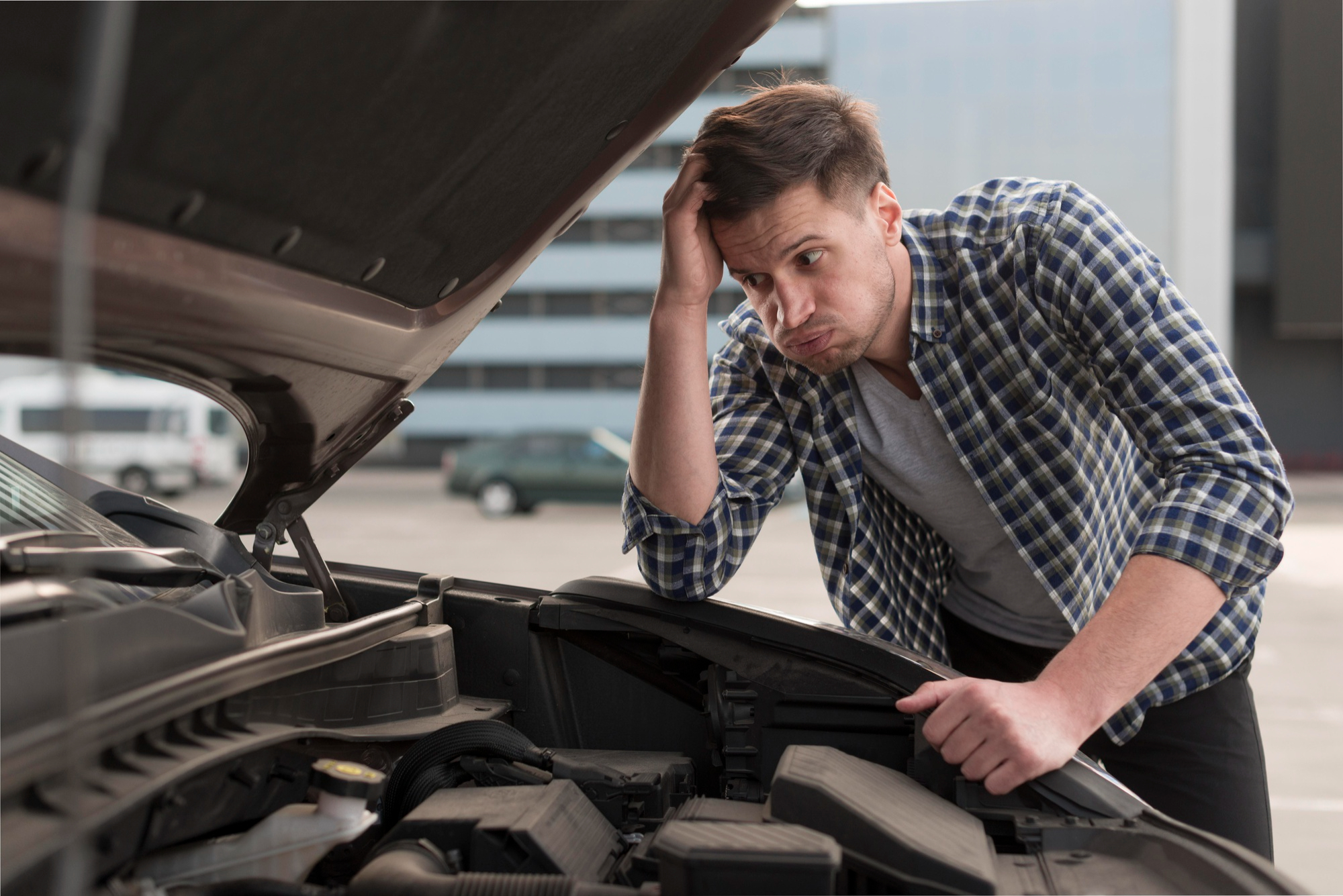 A frustrated man with car troubles | Source: Freepik