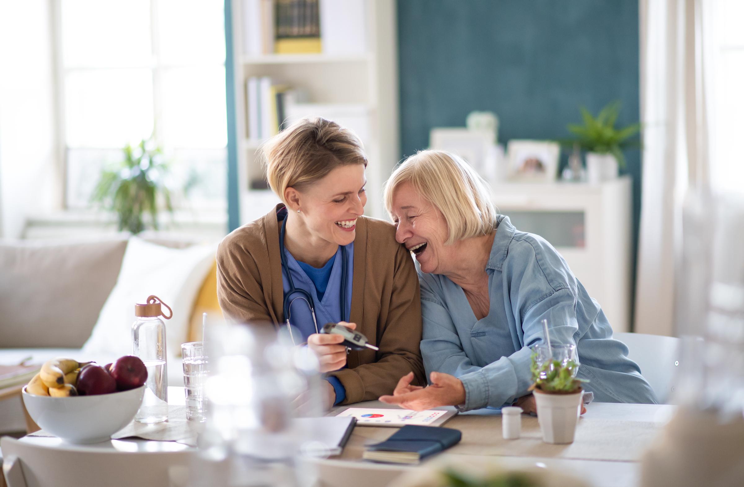 Nurse Practitioner making her patient smile while performing a diagnostic test | Source: Shutterstock