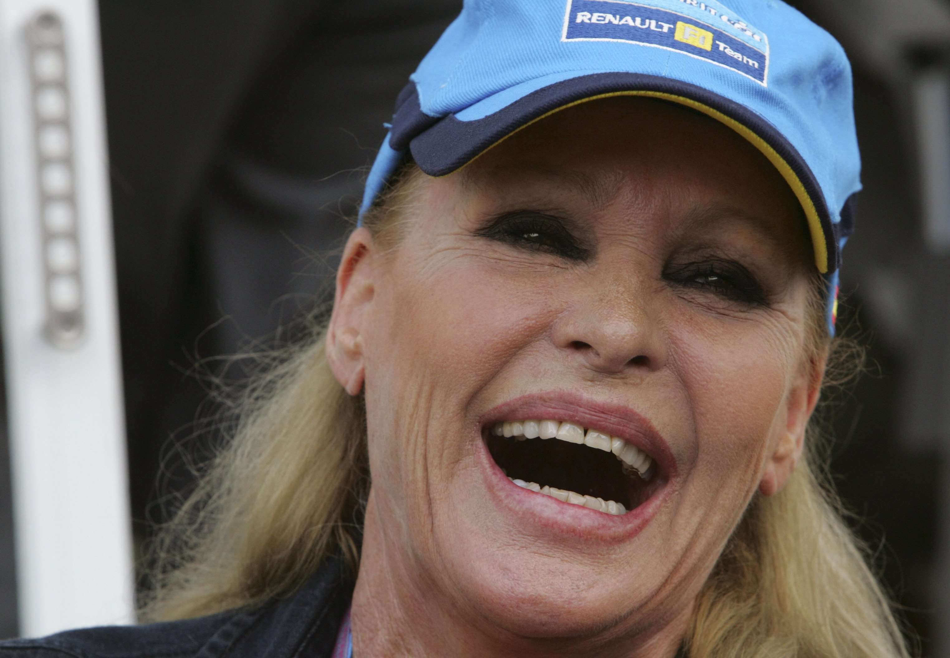 Ursula Andress laughs in the paddocks of the Istanbul racetrack before the start of the Turkish Grand Prix, in Istanbul, Turkey, August 21, 2005. | Source: Getty Images