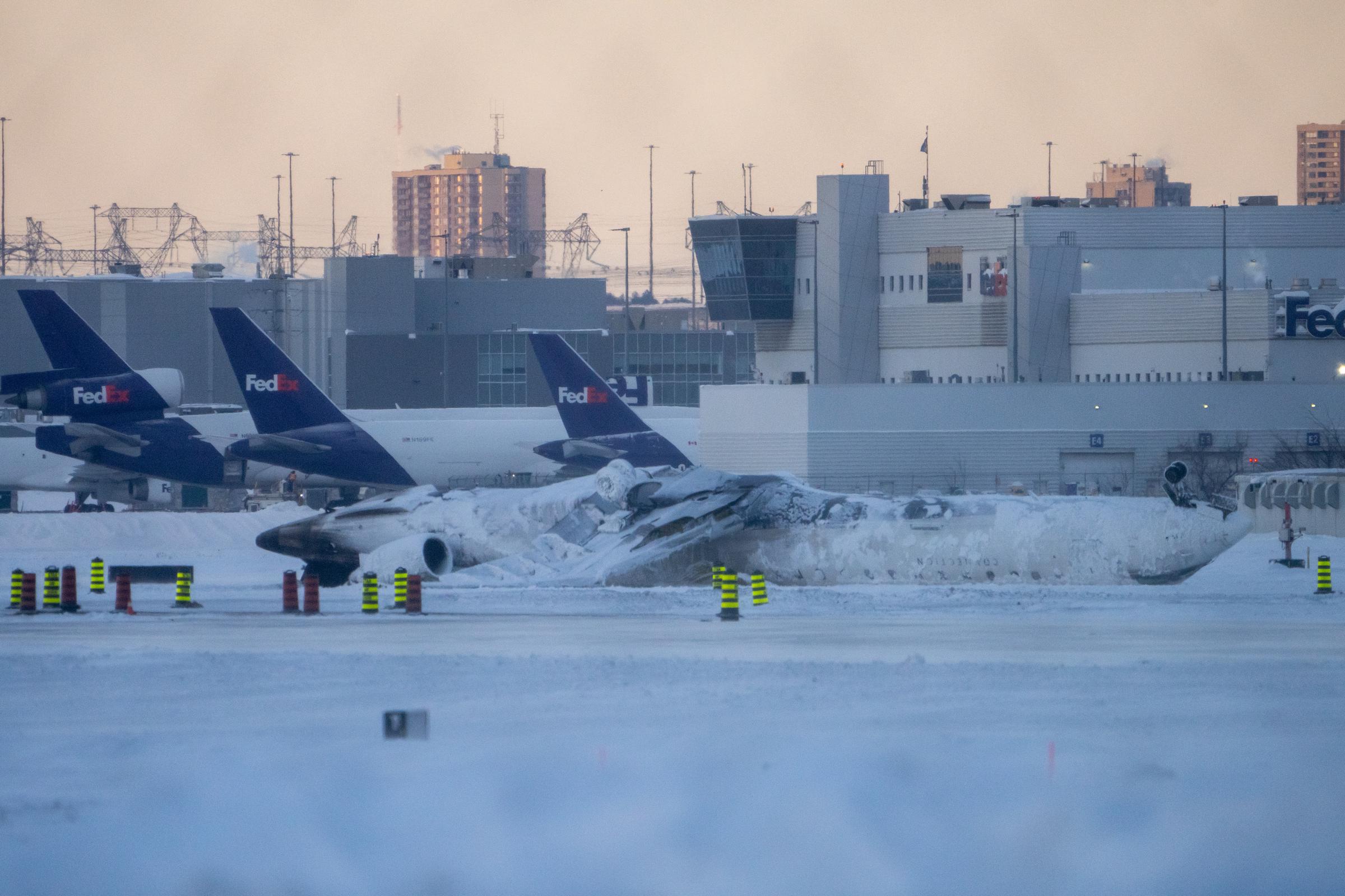 The Delta Airline plane covered in snow after it crashed at Toronto Pearson International Airport in Toronto, Canada on February 18, 2025. | Source: Getty Images