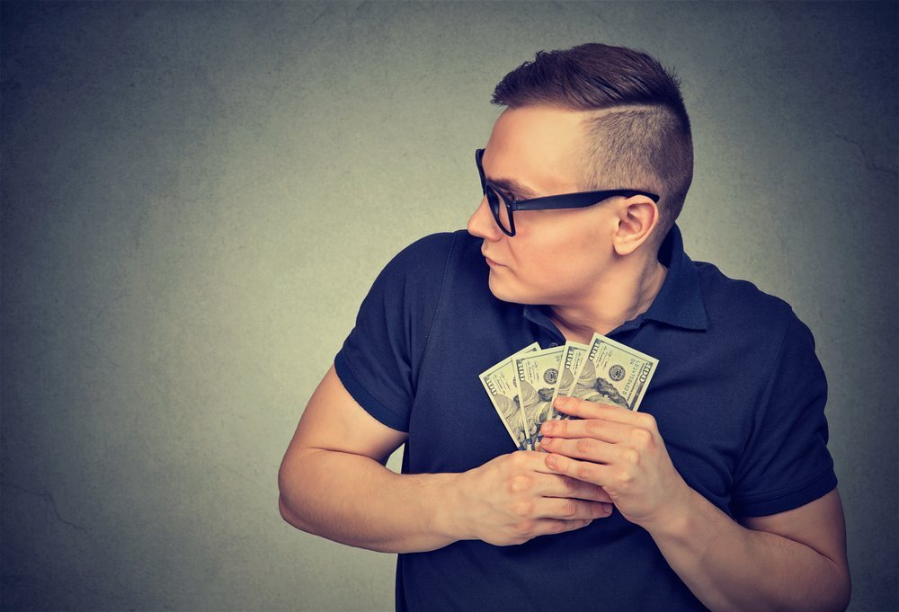 Selfish Man grabbing Money | Photo: Shutterstock 