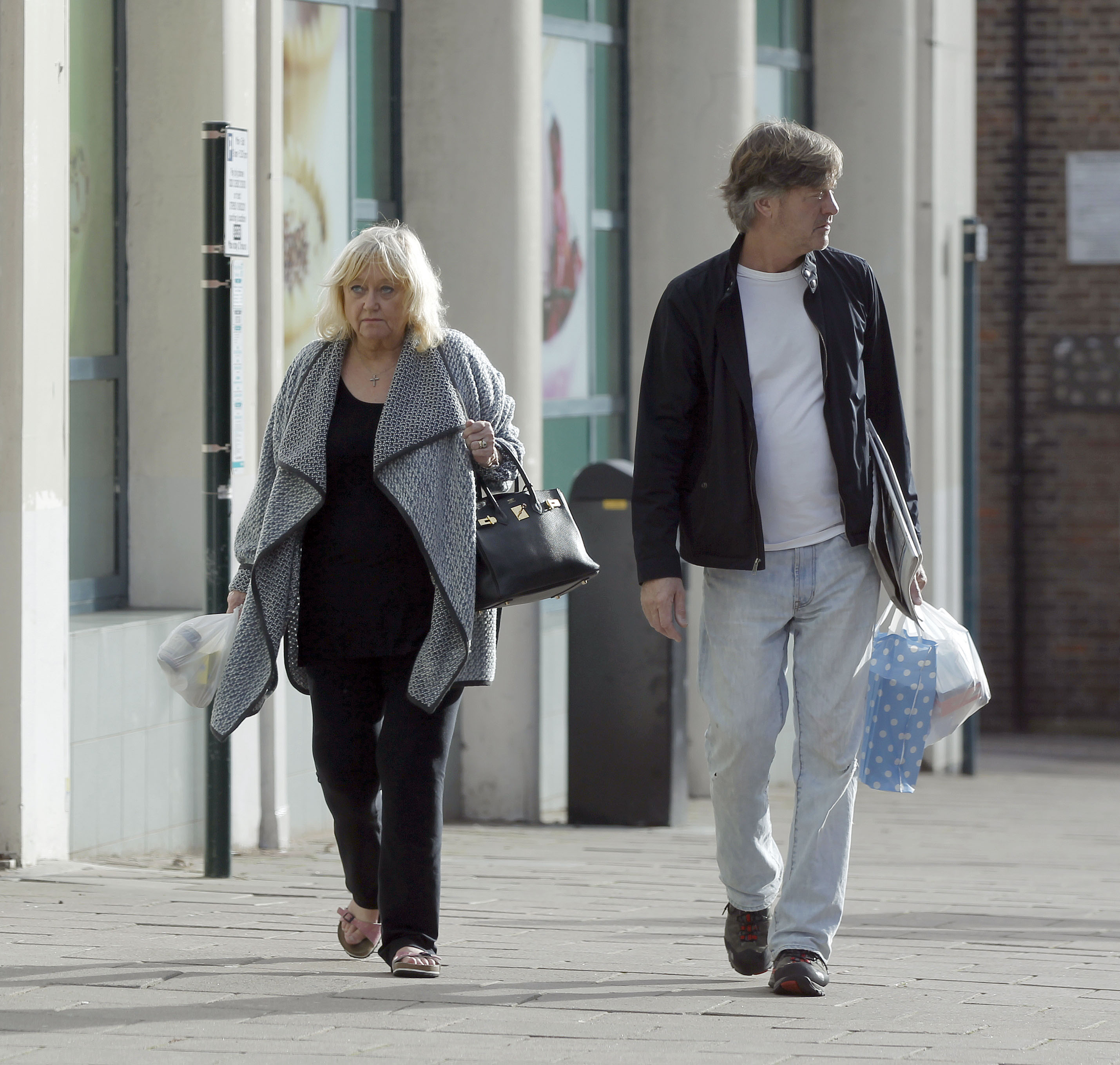 Judy Finnigan and Richard Madeley are spotted out in London on 12 November 2015, walking side by side with shopping in hand — an unguarded glimpse into their day-to-day routine, far removed from the studio setting, where their enduring partnership continues quietly beyond the public gaze.