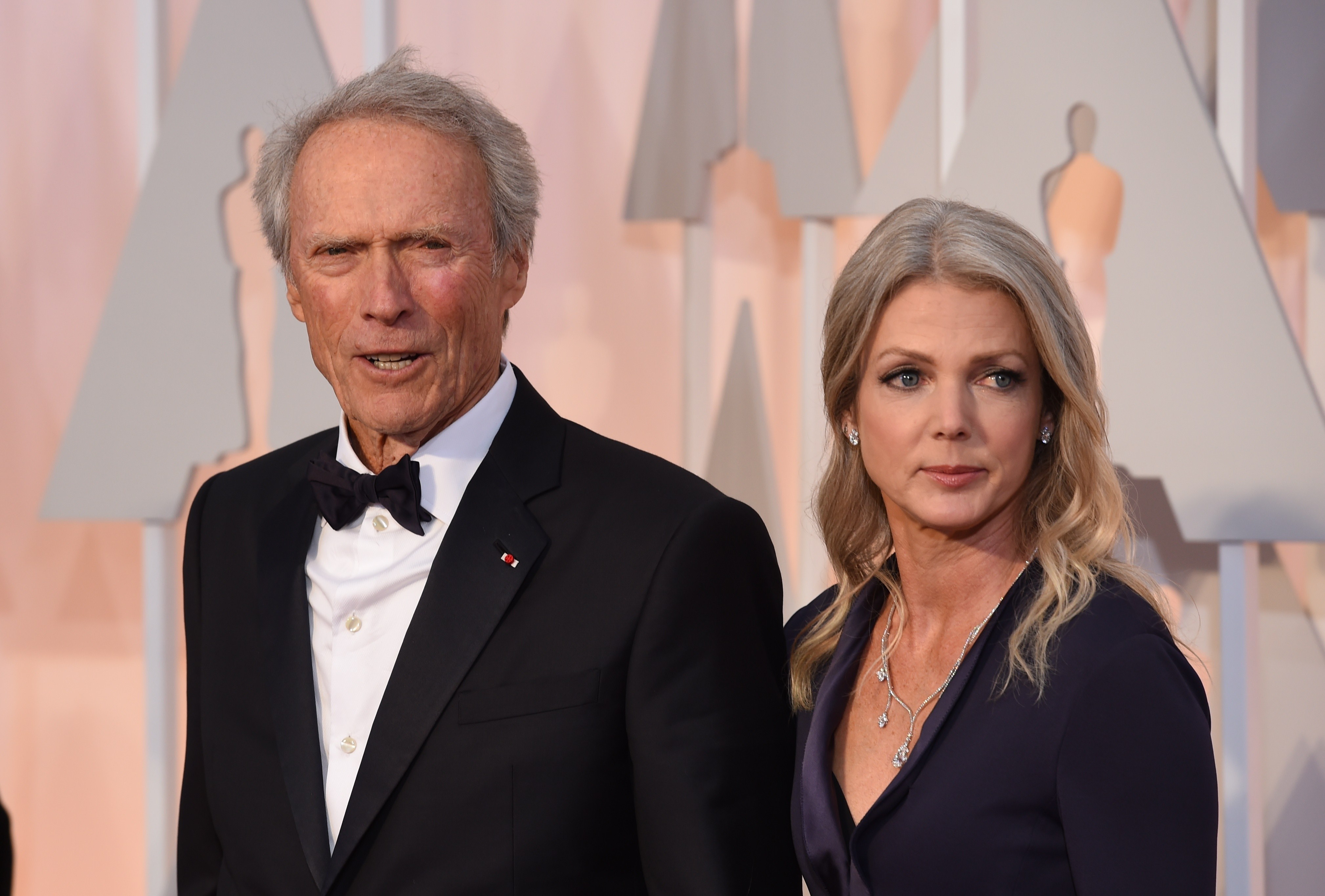 Clint Eastwood and Christina Sandera at the 87th Oscars in Hollywood, California on February 22, 2015 | Source: Getty Images