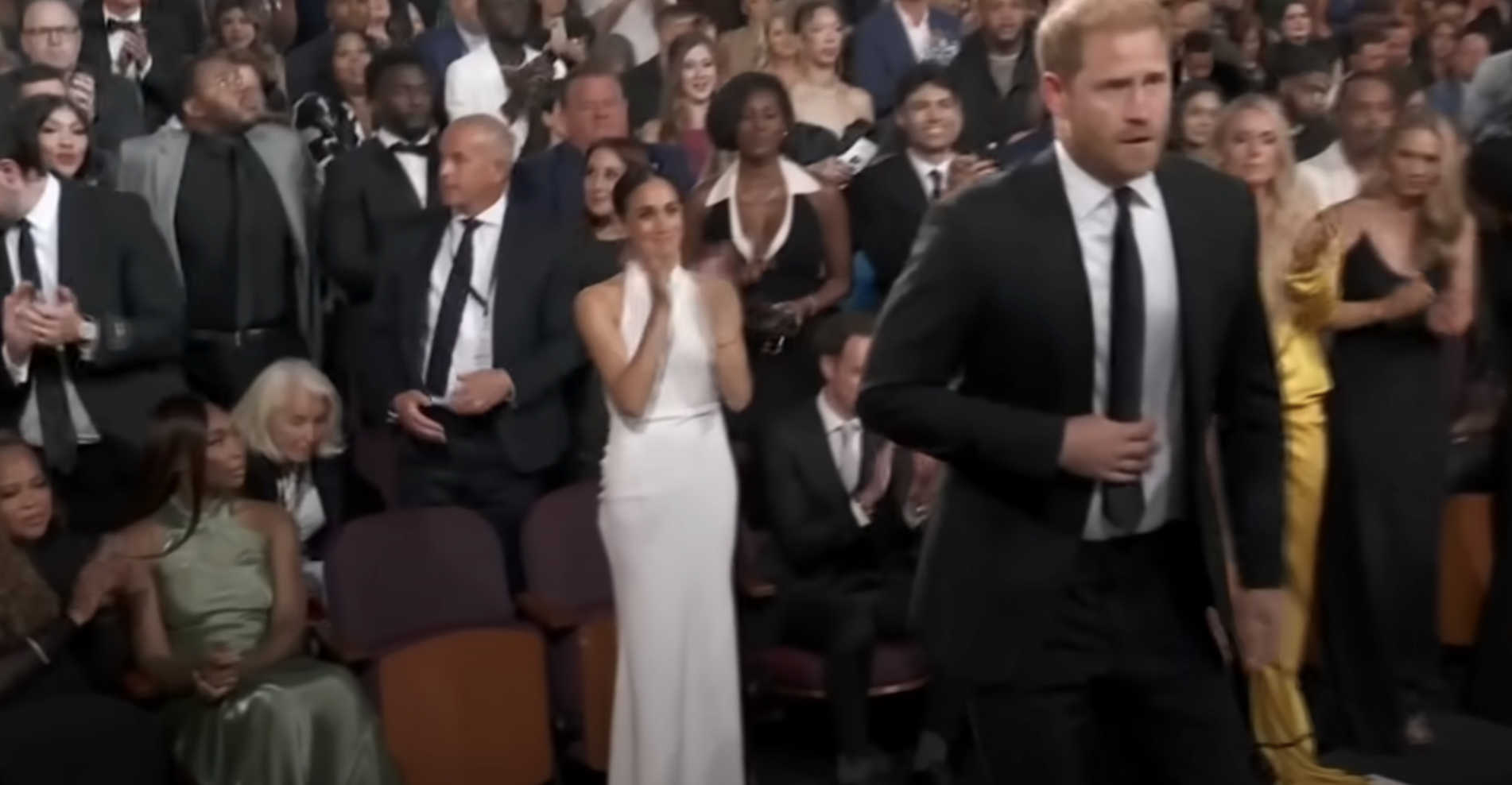 Meghan Markle applauds from the back as Prince Harry walks up the stage to accept the Pat Tillman Award on July 11, 2024. | Source: YouTube/espn