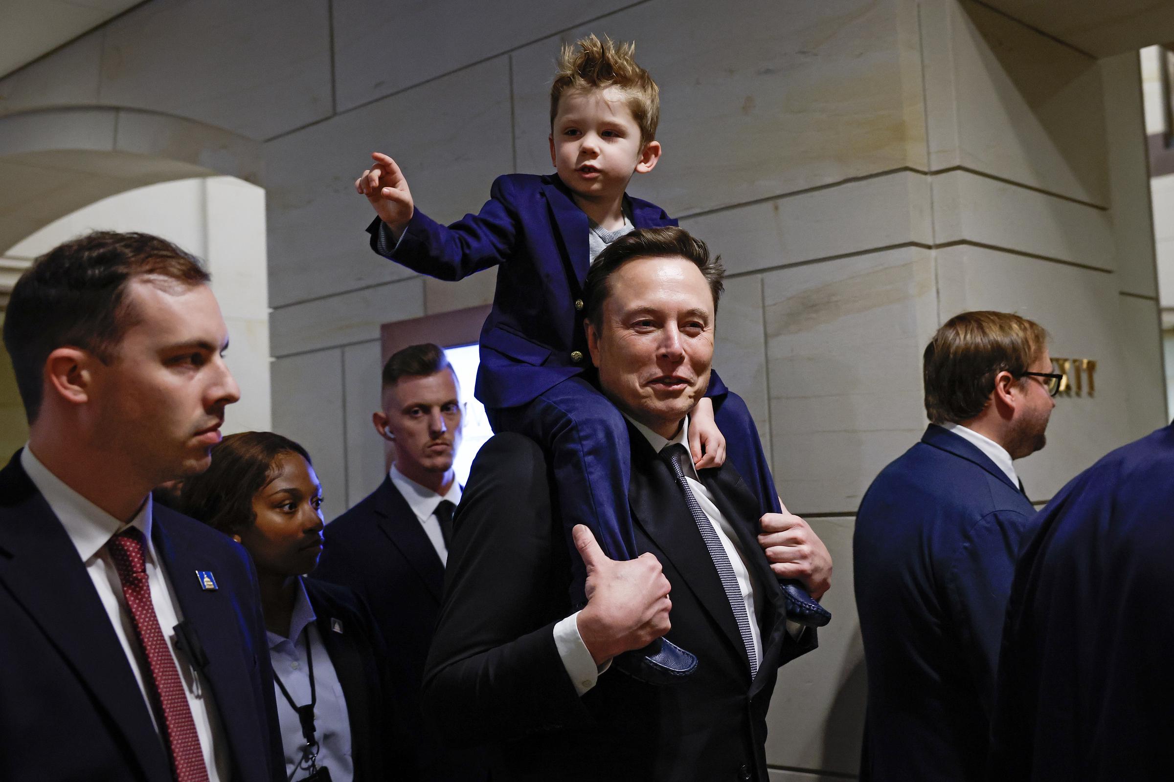 Elon Musk arriving with his son for a meeting with members of the U.S. Congress in Washington, D.C. on December 5, 2024. | Source: Getty Images