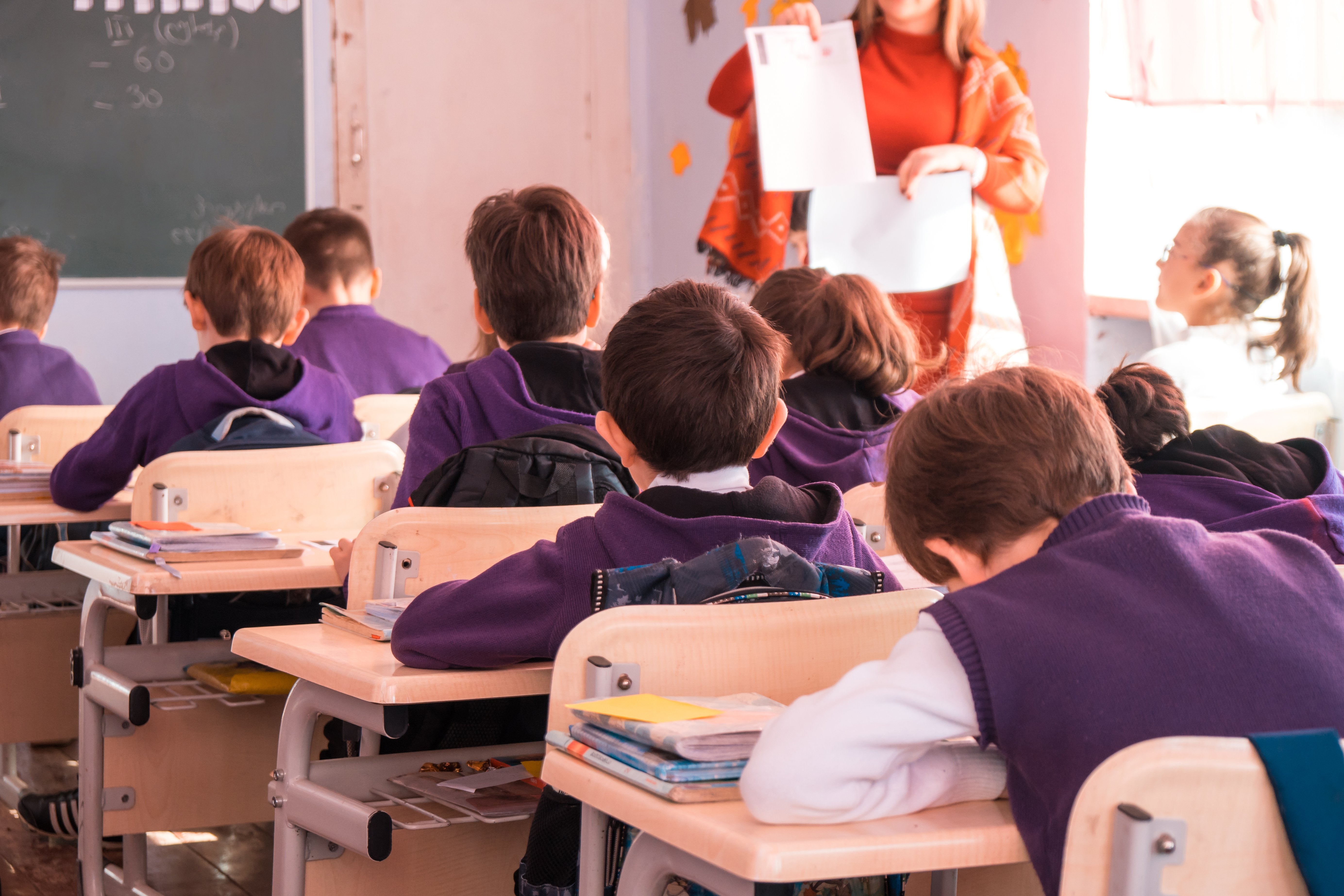 School children participating actively in class | Shutterstock.com