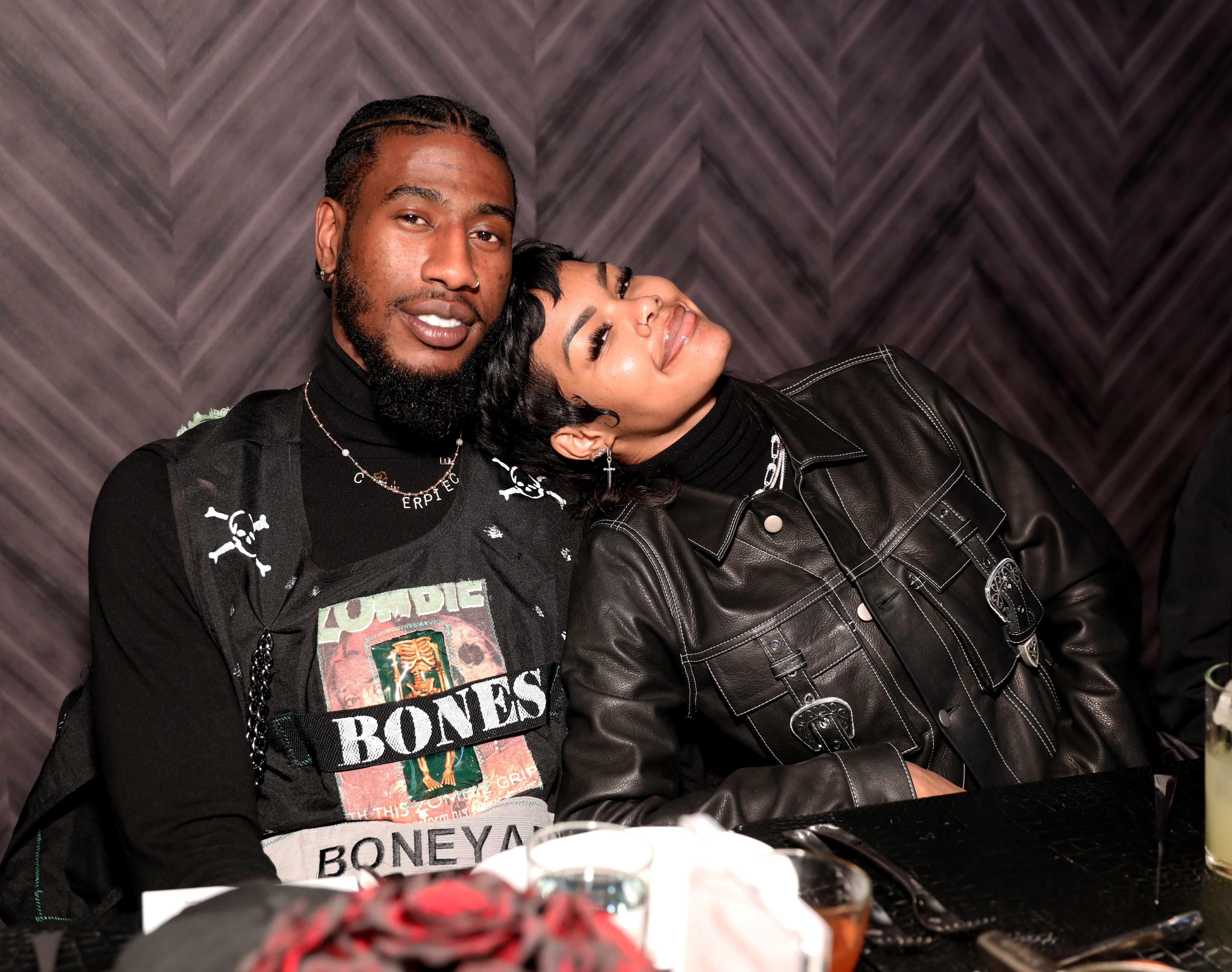 Iman Shumpert and Teyana Taylor sit close at an NBA All-Star dinner in Chicago. Teyana leans on Iman's shoulder in a black leather jacket as the pair share a relaxed, affectionate moment on February 14, 2020.