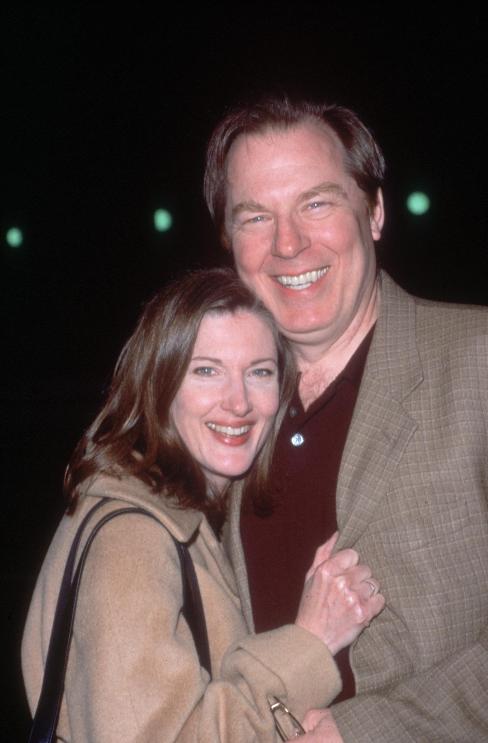 Michael McKean and Annette O'Toole smile while embracing at the premiere of director Eric Schaeffer's film "Wirey Spandell" in 2000 in Los Angeles, California | Source: Getty Images