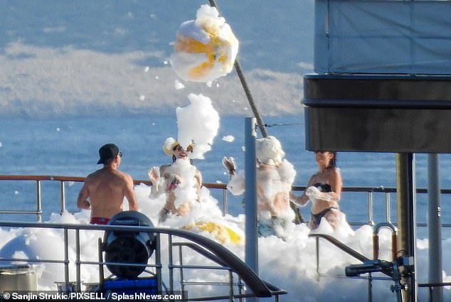 Lauren Sanchez and her billionaire beau Jeff Bezos have shrugged off protestors with a rowdy foam party on board a $500million superyacht to kick off their opulent wedding-week festivities