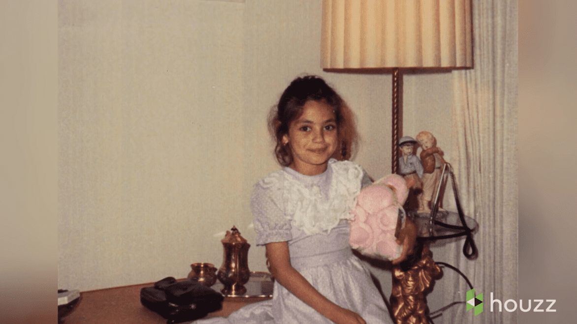 Mila Kunis as a young girl playing with a doll. | Source: YouTube/@HouzzTV