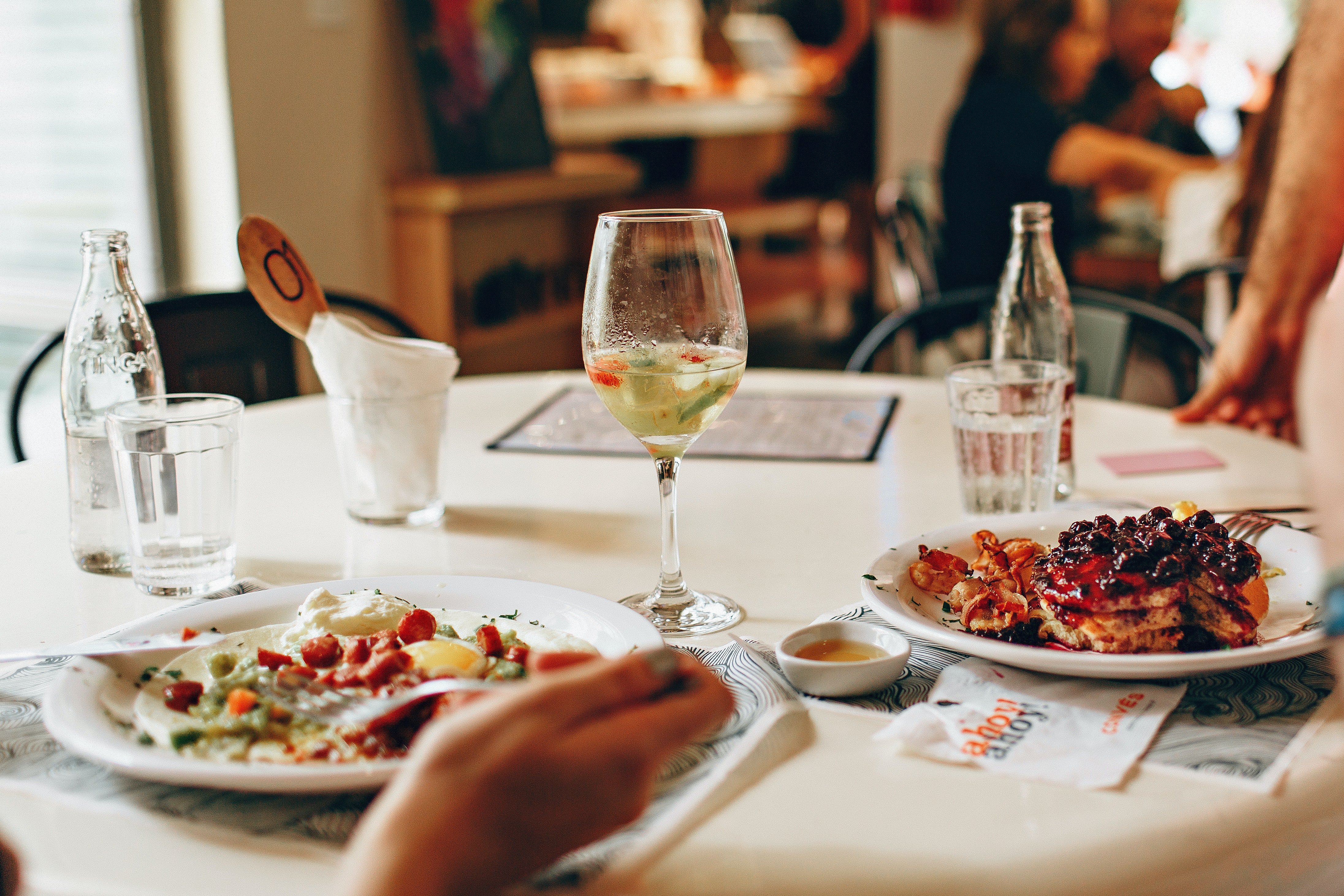 A table in a restaurant showing food served in plates. | Source: Pexels