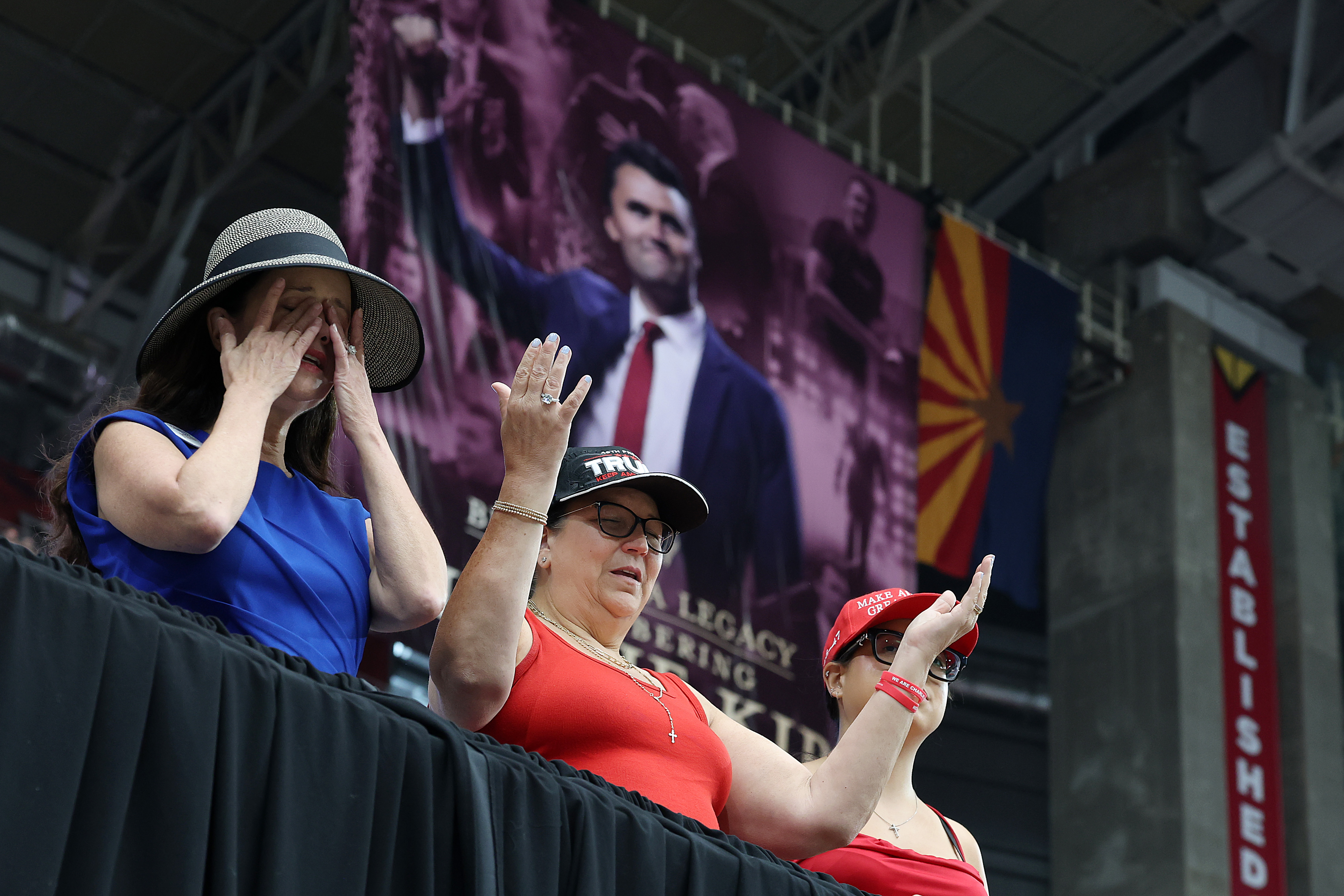 Mourners cry and pray during Charlie Kirk's memorial service on September 21, 2025 in Glendale, Arizona | Source: Getty Images