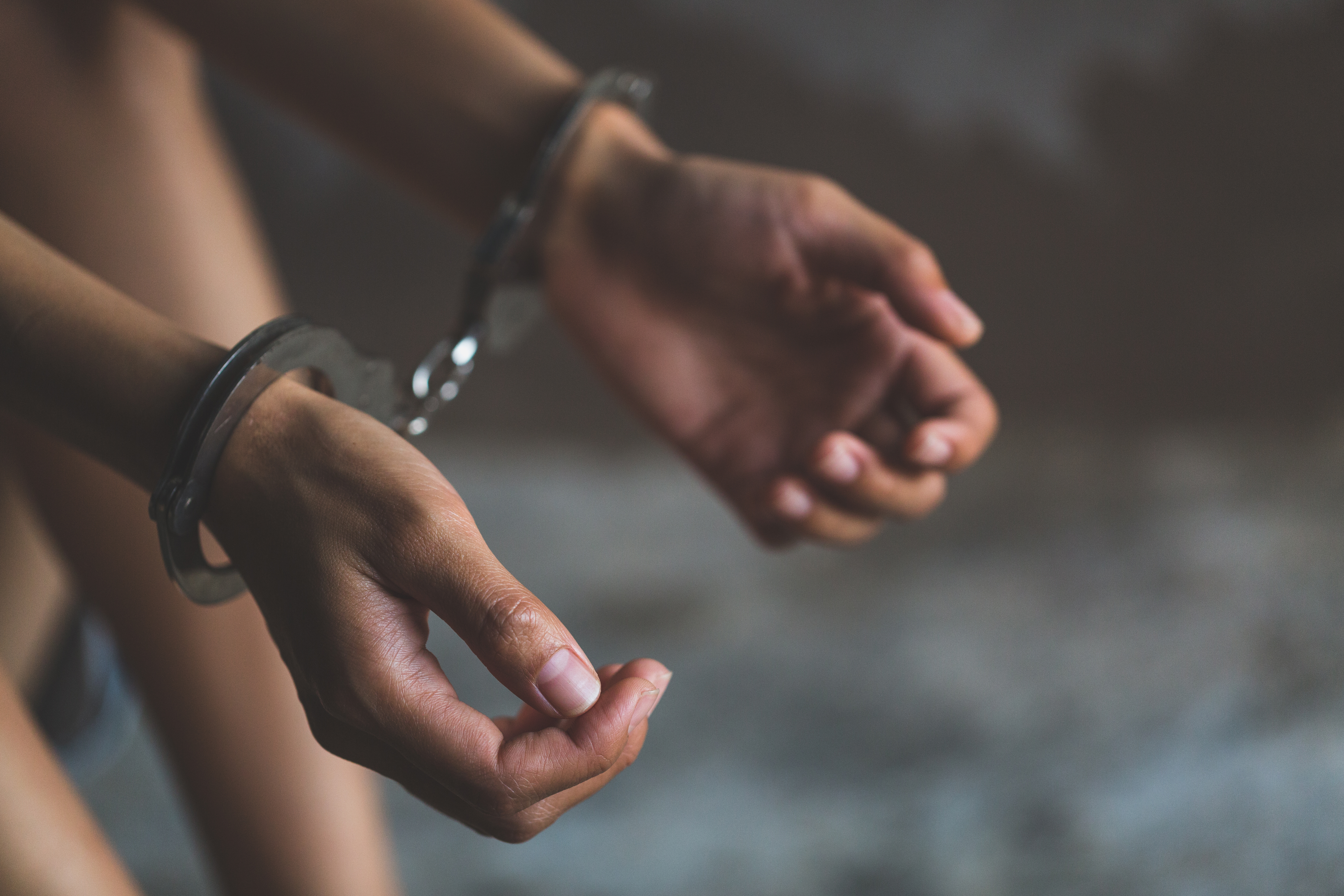 Close-up of hands in handcuff | Source: Shutterstock