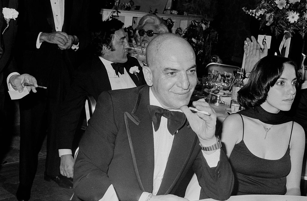 Telly Savalas with his girlfriend at a formal dinner; circa 1960 in New York | Photo: Getty Images