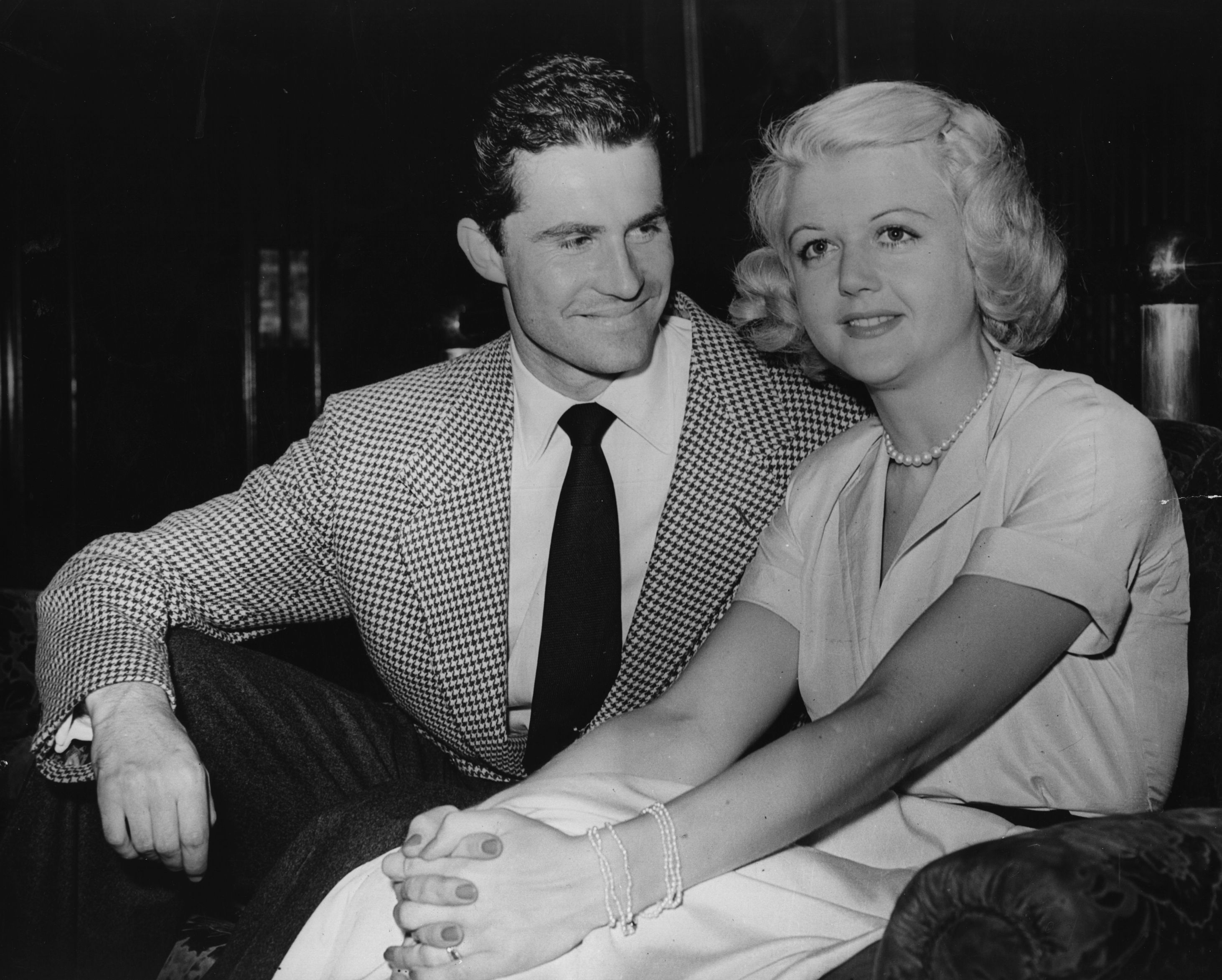 British actress Angela Lansbury with Peter Shaw on their arrival at London Airport before their wedding | Source: Getty Images