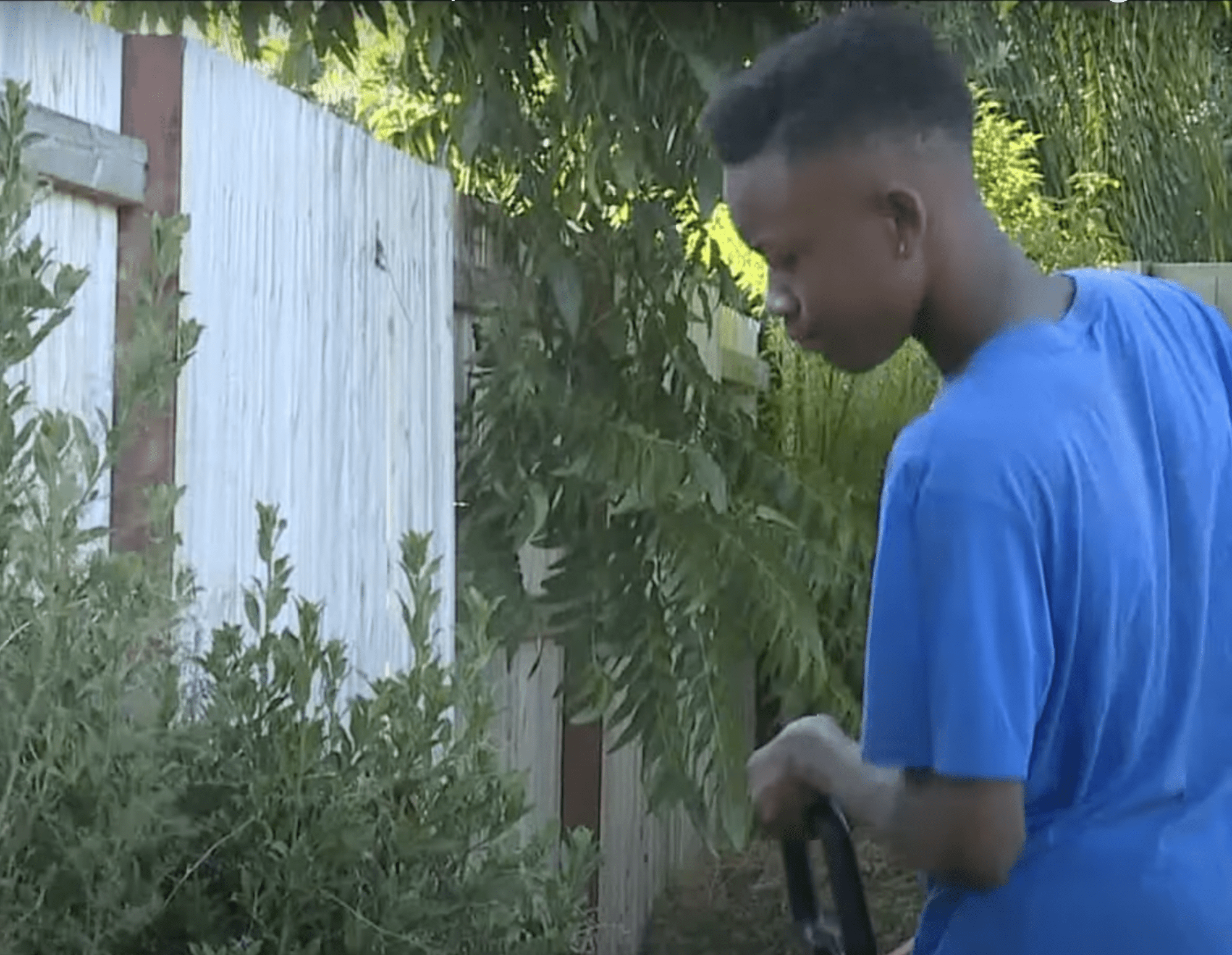 Johnson pictured mowing the lawn. | Source: youtube.com/FOX40 News