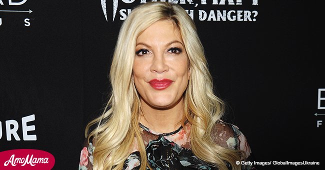 Tori Spelling shows off her impossibly slim waist in an angelic white dress at recent outing