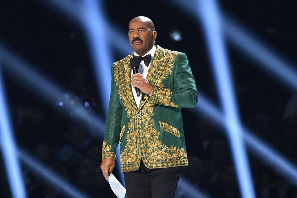 Steve Harvey Wears Purple Suit While Doing His Own Ironing In Video