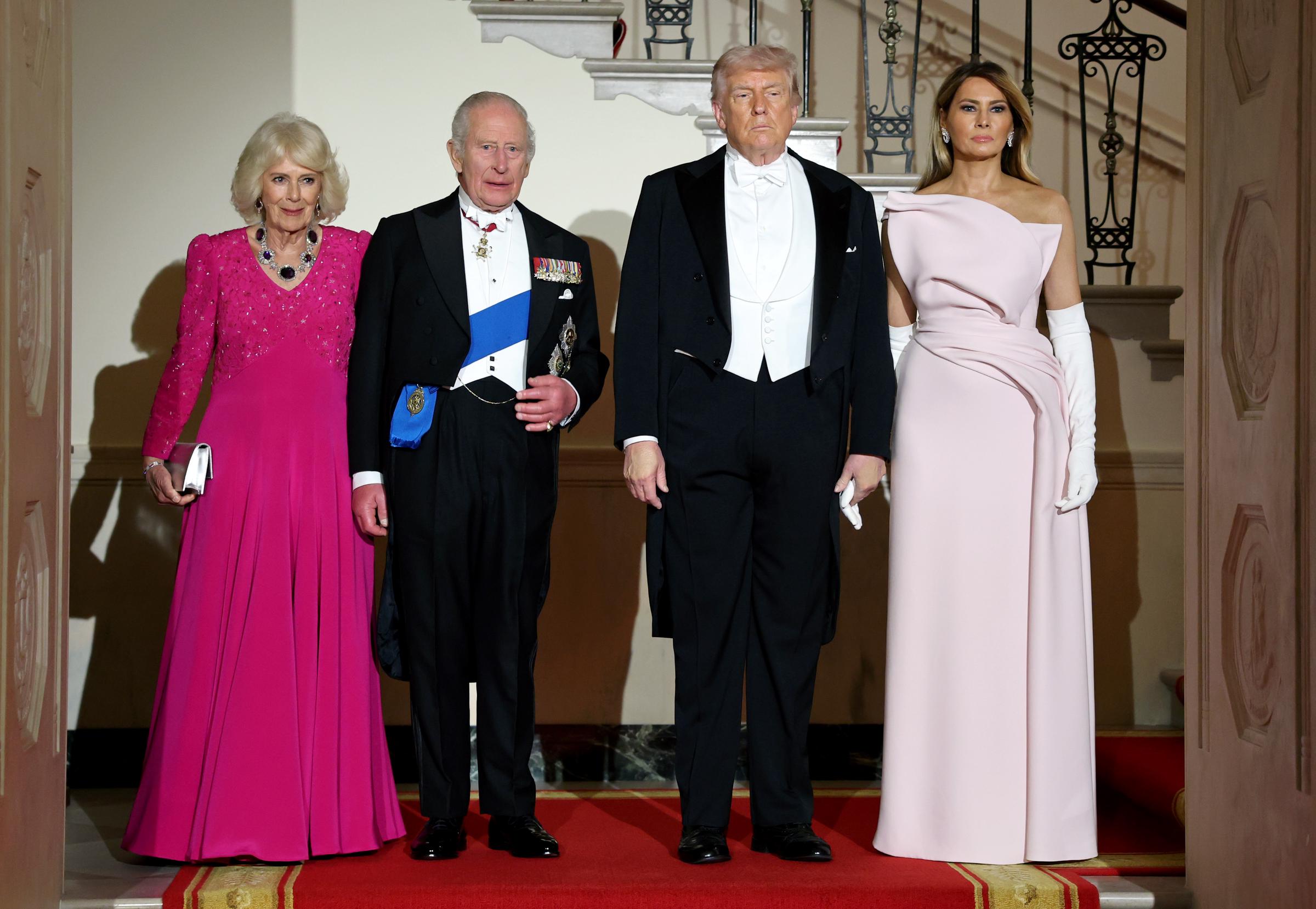 Queen Camilla, King Charles III, U.S. President Donald Trump, and First Lady Melania Trump descend the Grand Staircase during an official state dinner hosted by the President and First Lady at The White House on day two of the State Visit of King Charles III and Queen Camilla to the United States of America, on 28 April 2026 in Washington, DC. | Source: Getty Images