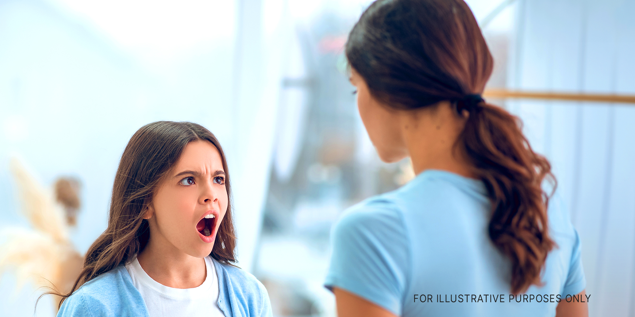 A teenage girl is seen screaming at the woman standing in front of her | Source: Shutterstock