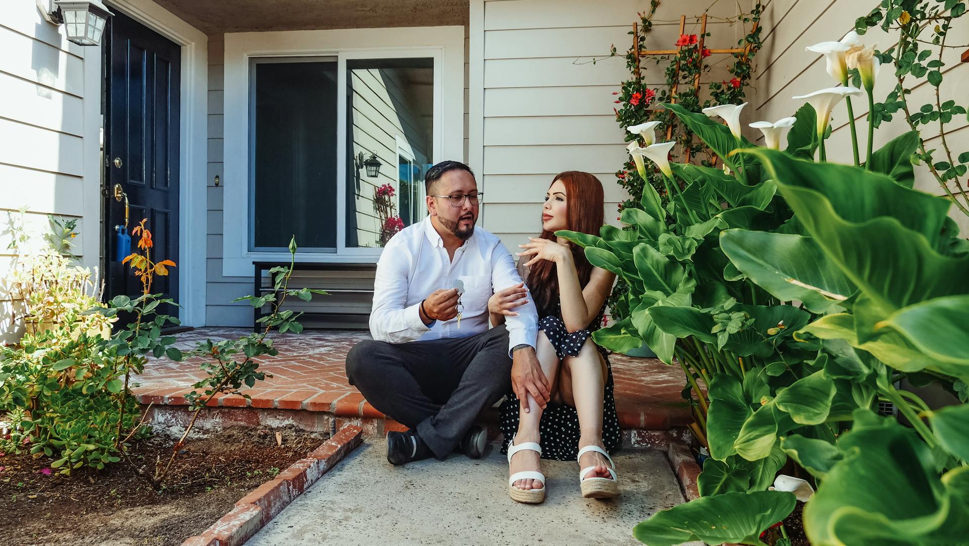 A couple sitting outside their house | Source: Pexels