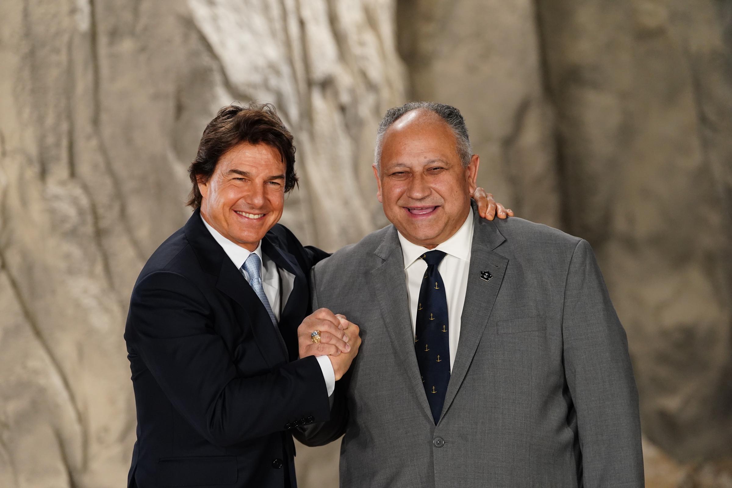 Tom Cruise and US Secretary of the Navy, Carlos Del Toro at Long Cross, UK, on December 17, 2024 | Source: Getty Images