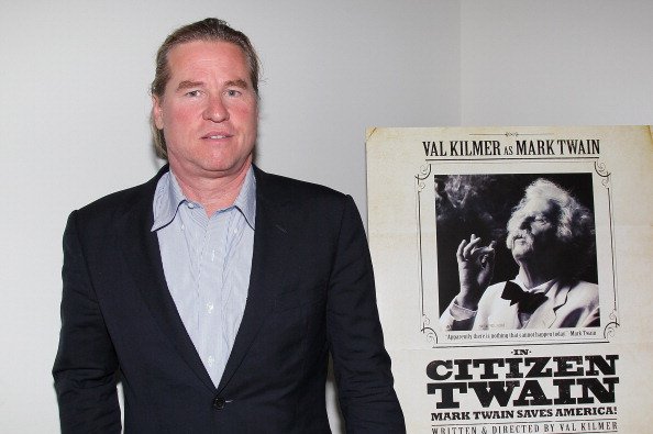 Veteran actor Val Kilmer posed beside a poster of his 2012 show in California. | Photo: Getty Images