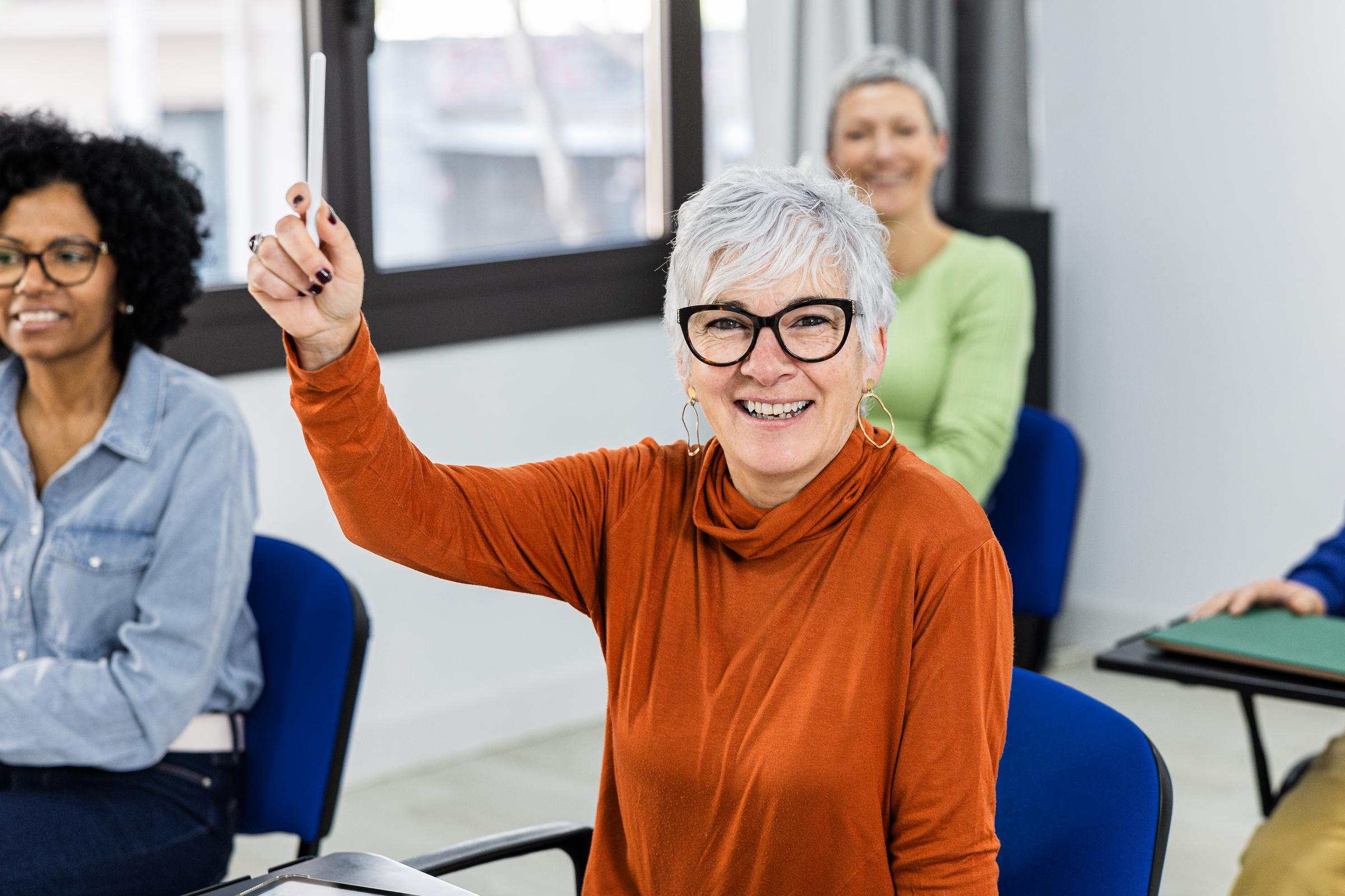 A student raising her hand to ask a question | Source: Getty Images