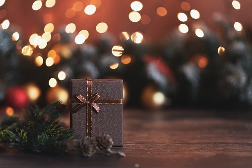 A wrapped Christmas box under a Christmas tree | Photo: Getty Images