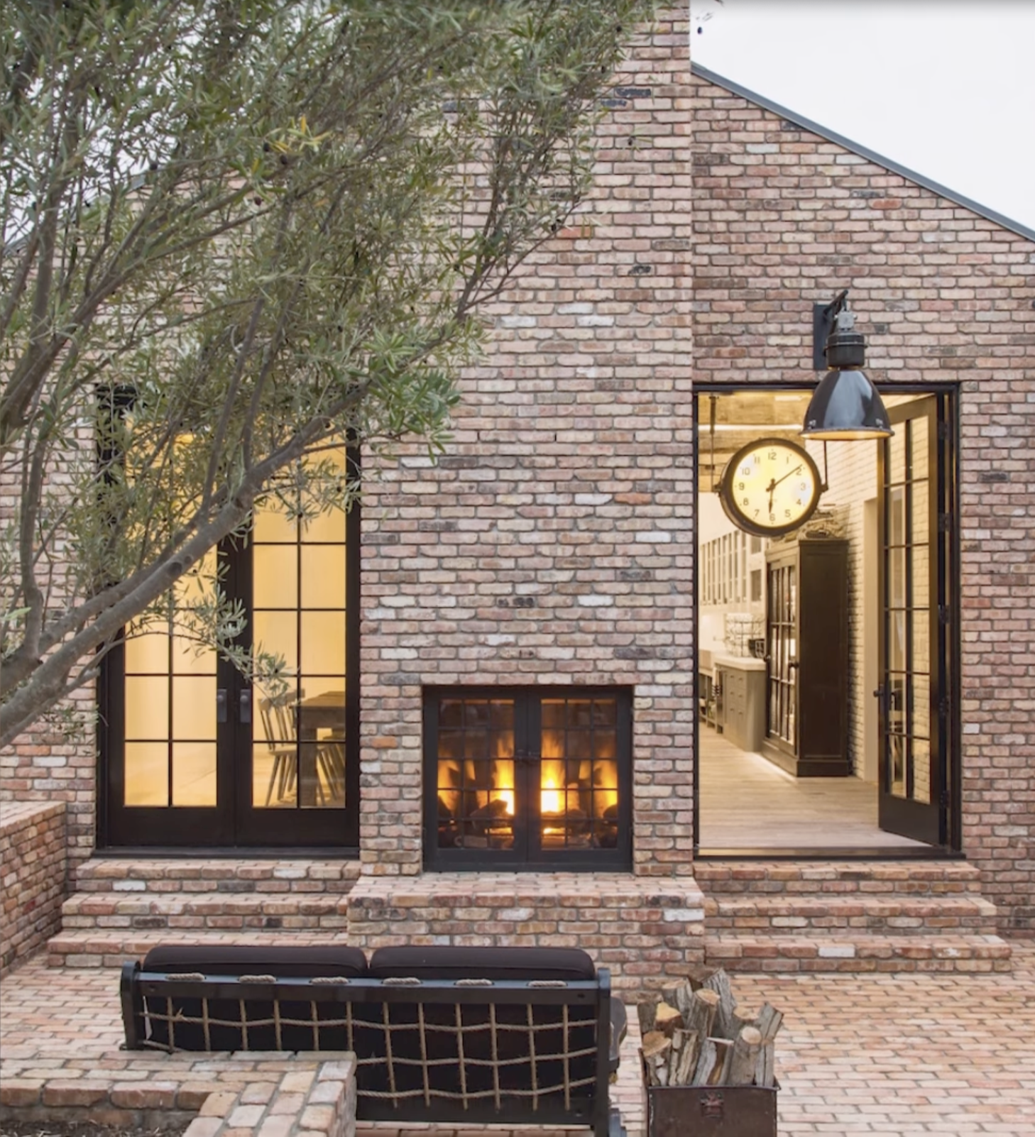 Outdoor seating area and brick exterior with fireplace and interior view of vintage clock inside Diane Keaton’s Sullivan Canyon home, dated February 3, 2022 | Source: YouTube/@FamousEntertainment500k
