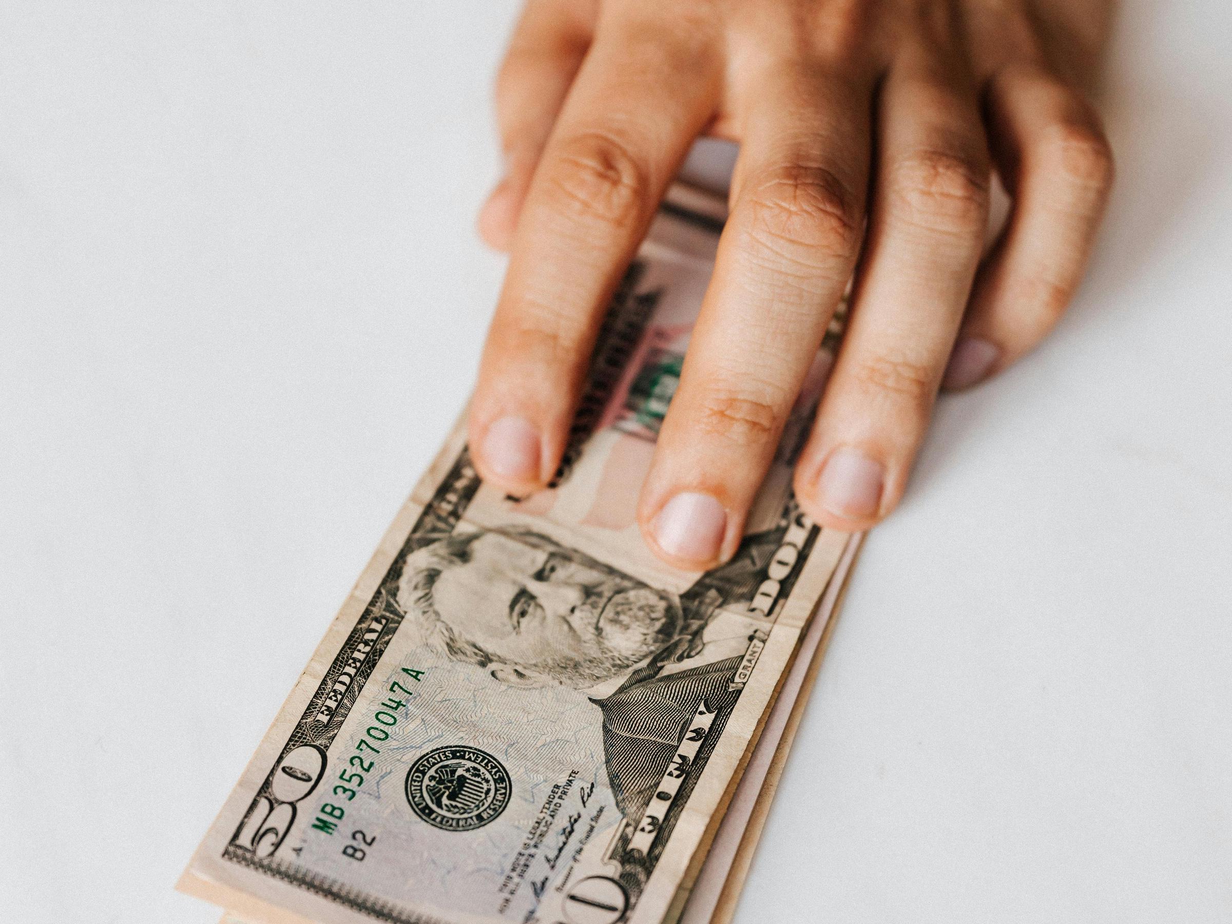 Cash bills on a tabletop | Source: Pexels