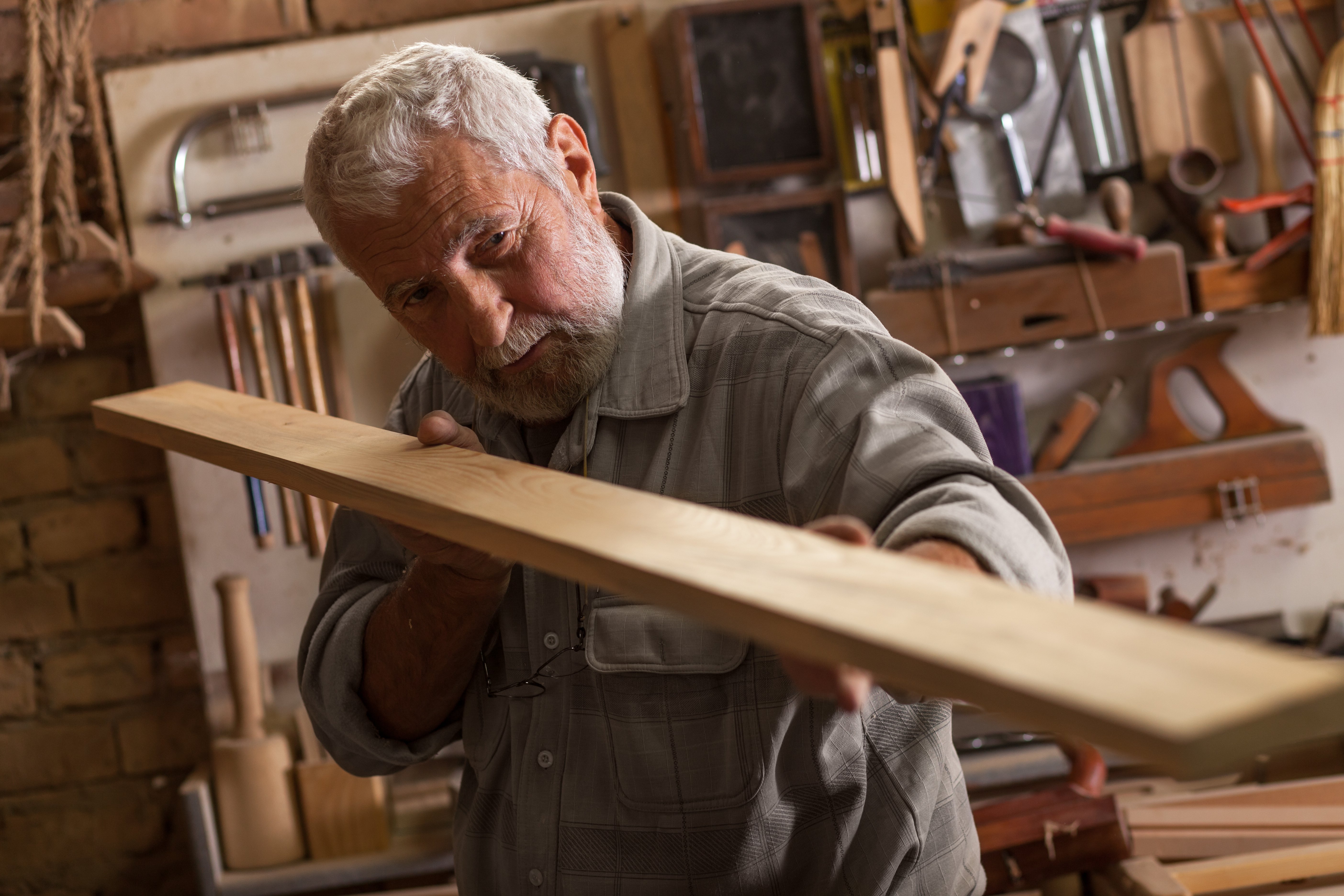 An old carpenter working on his craft | Photo: Shutterstock 