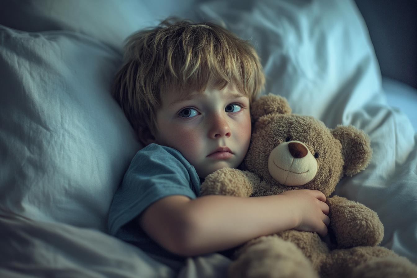 A sad little boy holding a teddy bear | Source: Midjourney