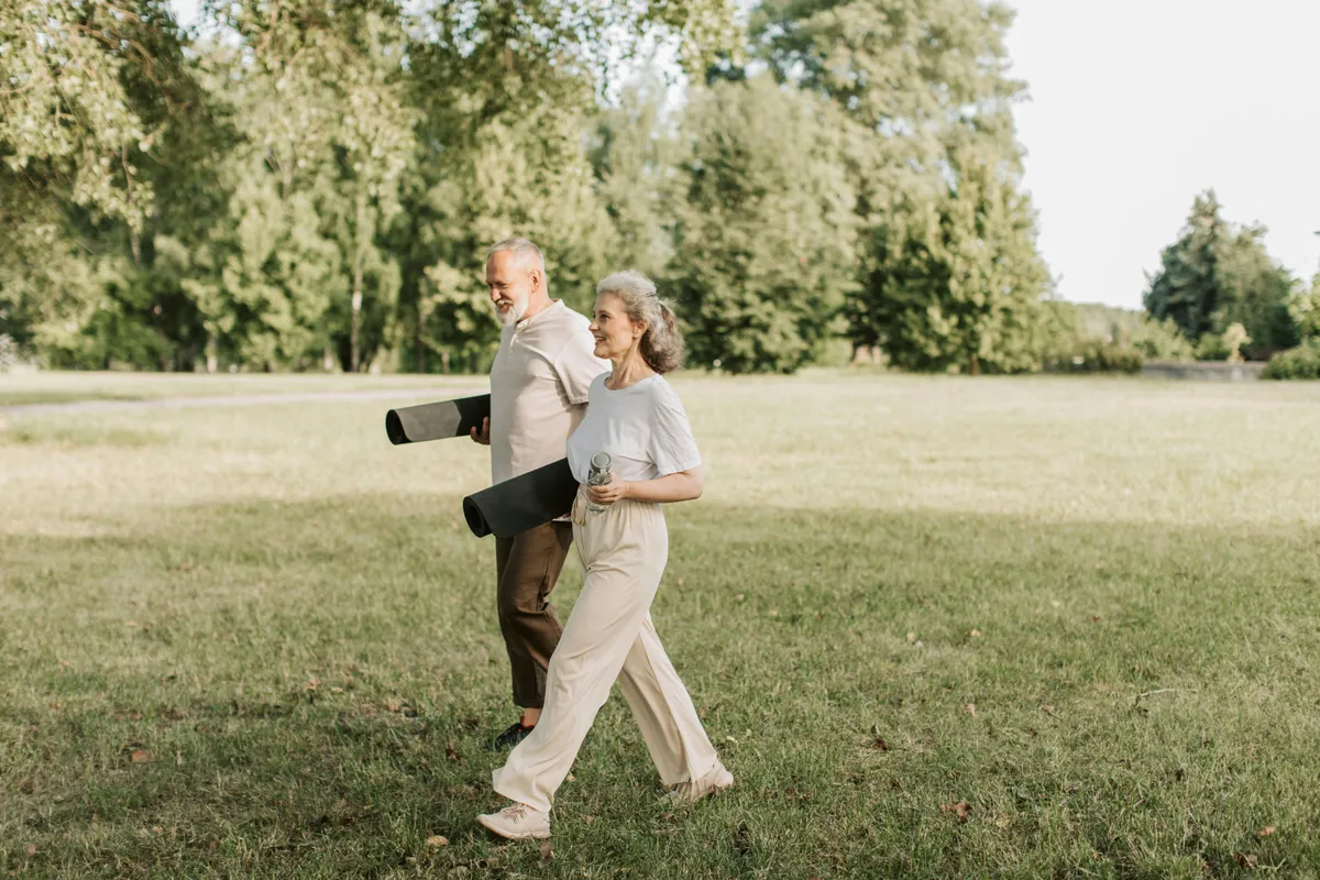 An older couple walking at the park | Source: Pexels