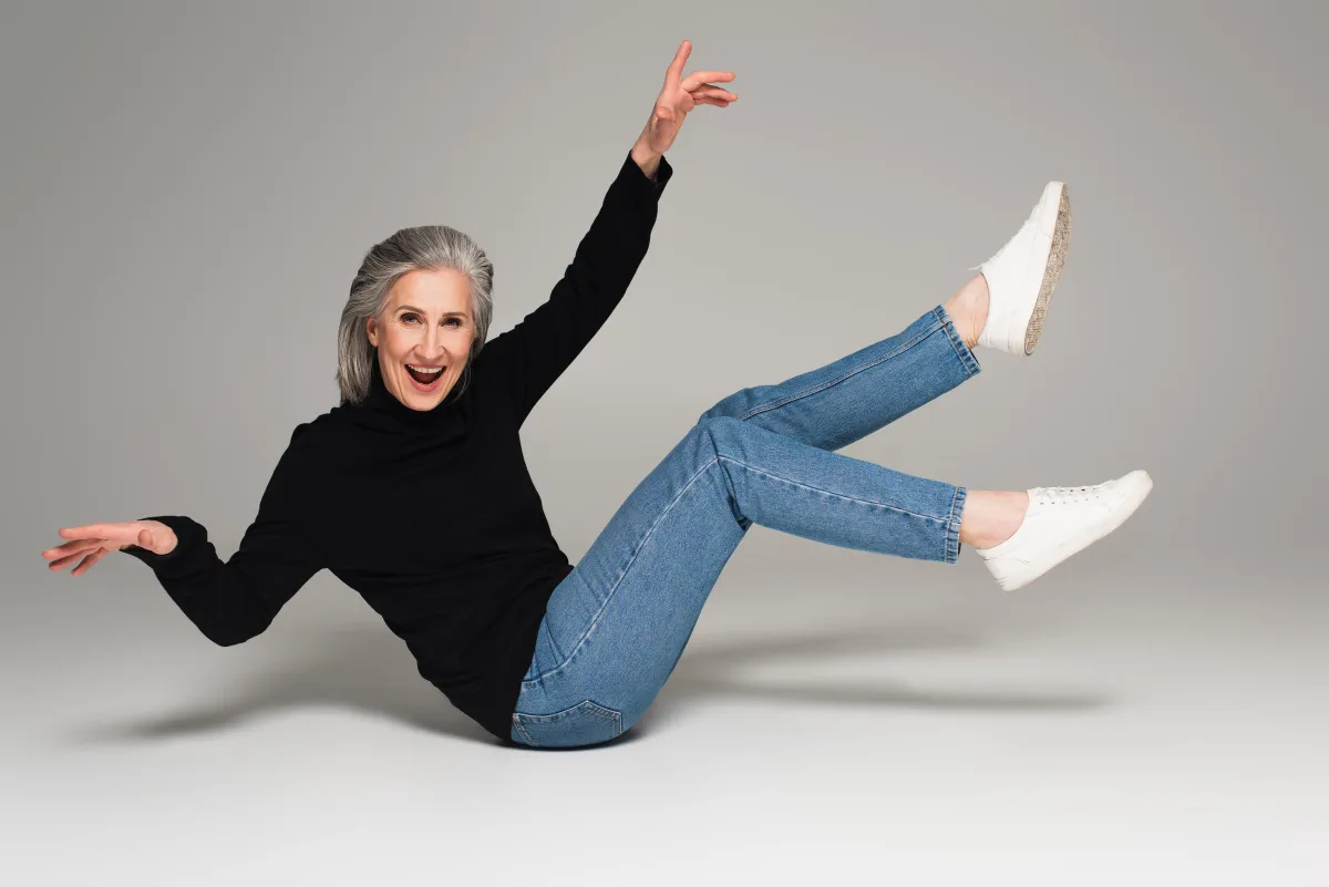 A woman having fun in classic jeans and a black sweater | Source: Shutterstock