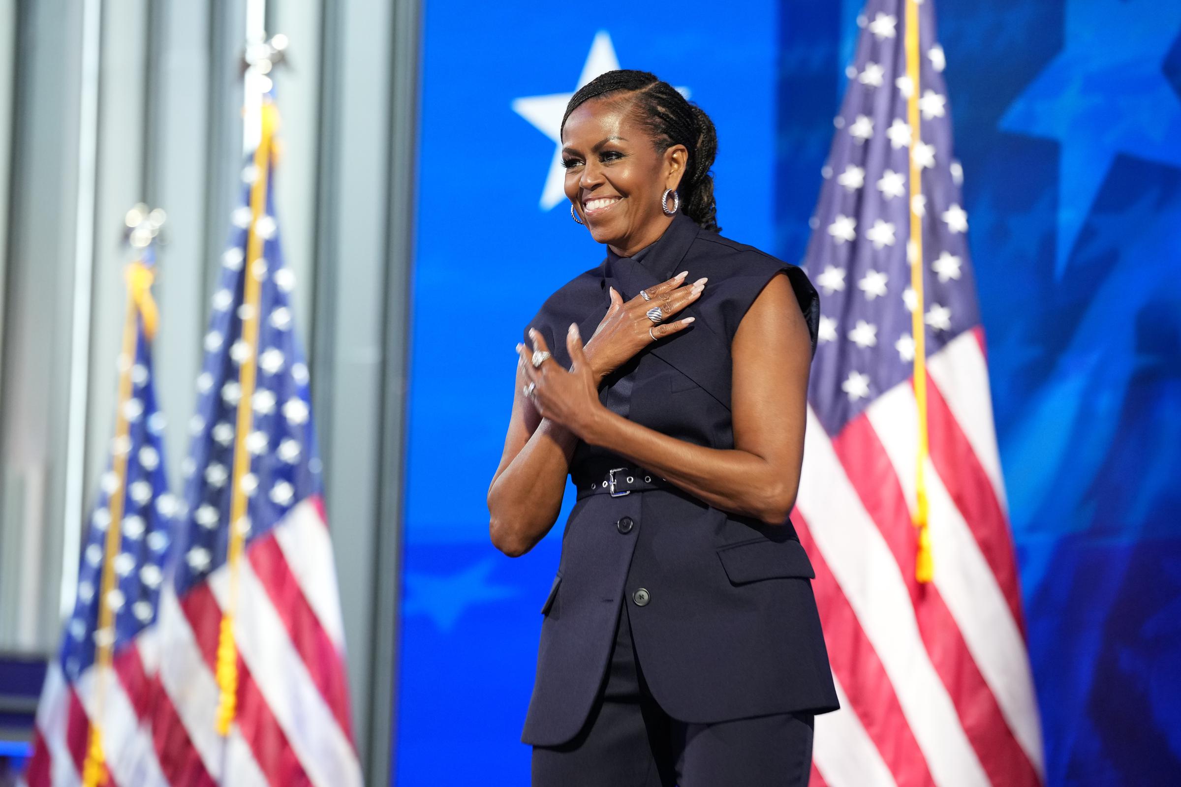 Former first lady Michelle Obama arrives to speak on stage during the second day of the Democratic National Convention at the United Center on August 20, 2024 in Chicago, Illinois. | Source: Getty Images