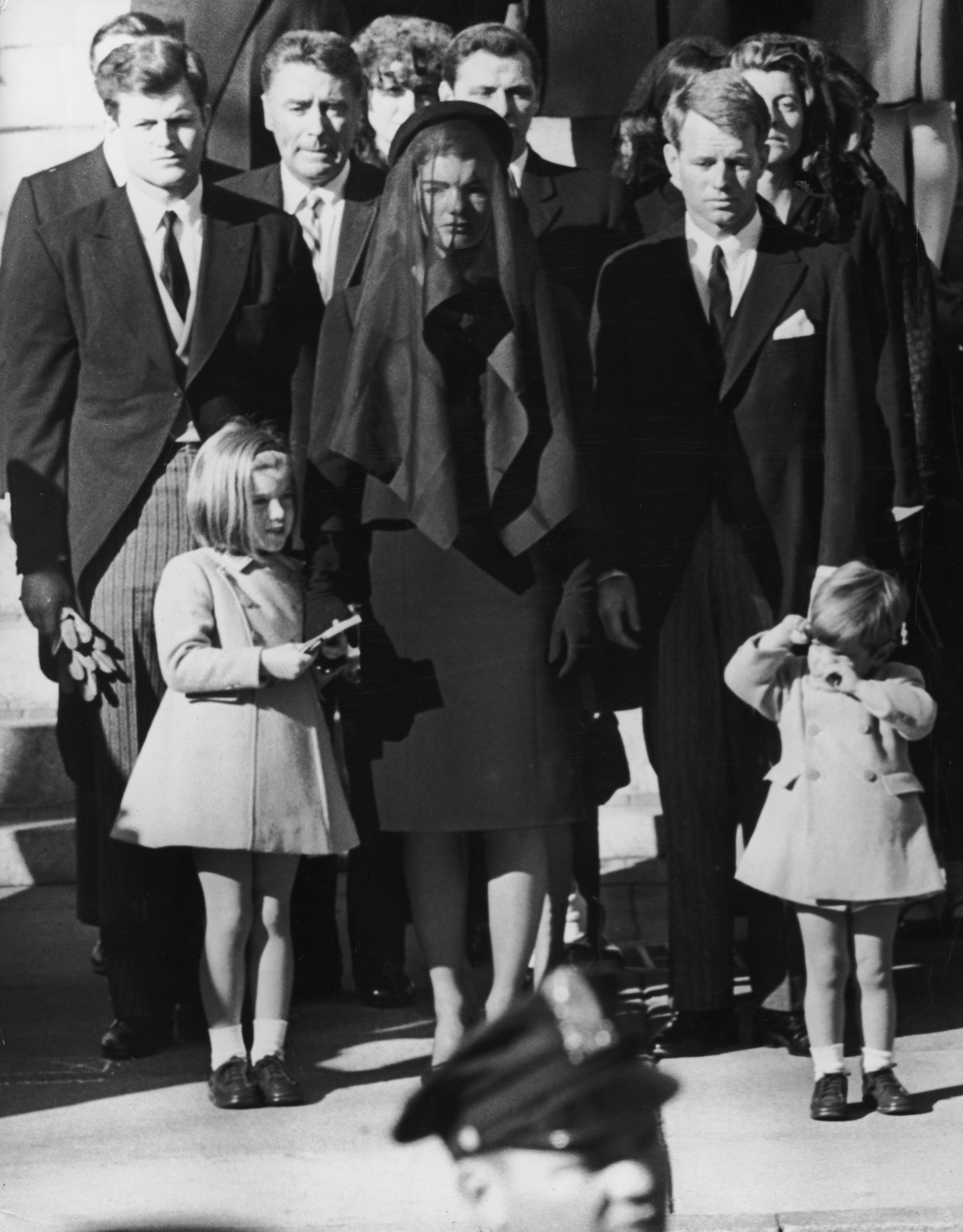 Jacqueline Kennedy with her children, Caroline and John Jr., and her brothers-in-law, Senator Edward "Ted" Kennedy and US Attorney General Robert Kennedy, leaving St. Matthew's Cathedral for U.S. late president John F. Kennedy's funeral on November 24, 1963. | Source: Getty Images