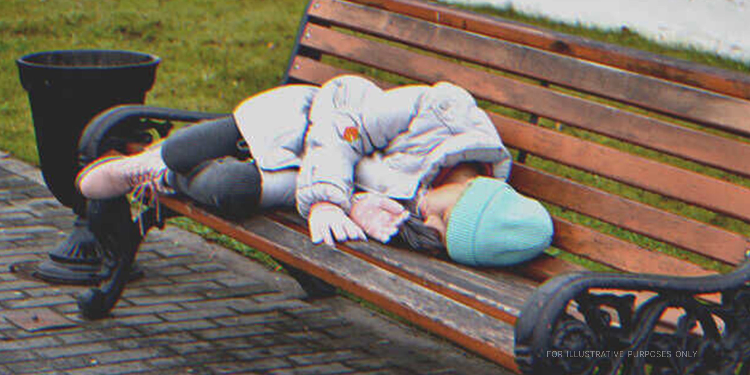 Child sleeping on a park bench | Shutterstock.com