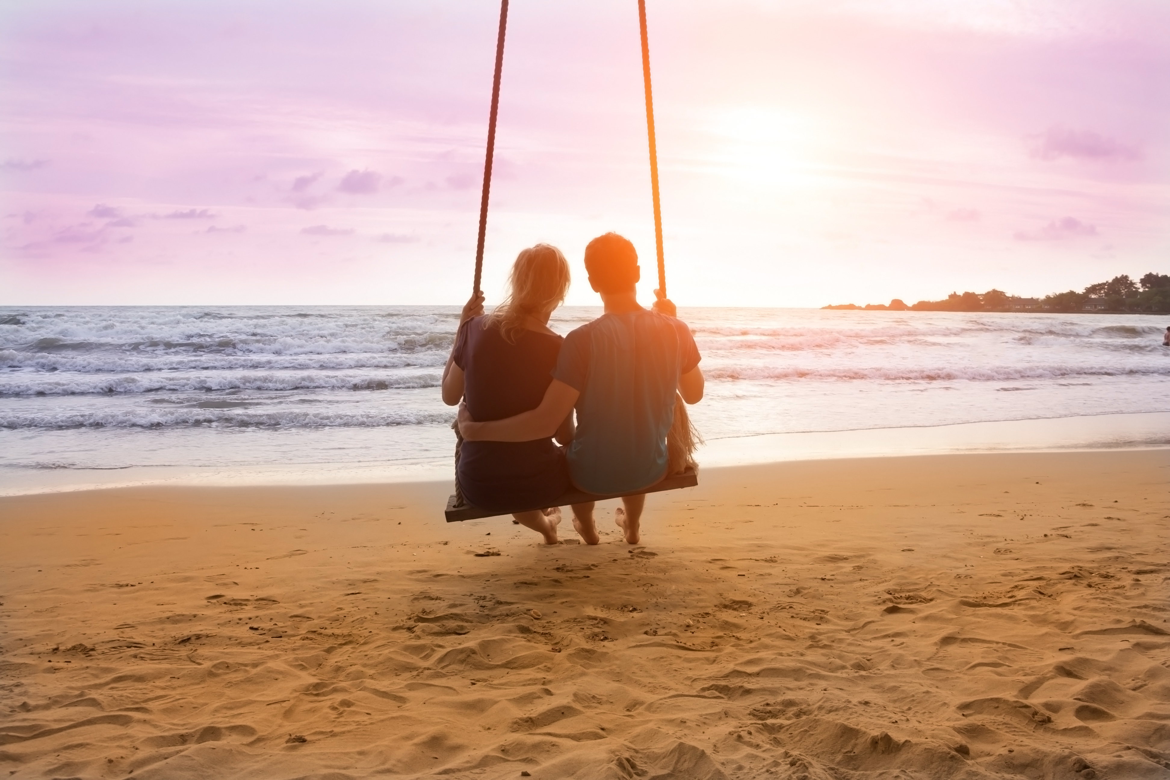 Couple sitting on the beach | Source: Shutterstock