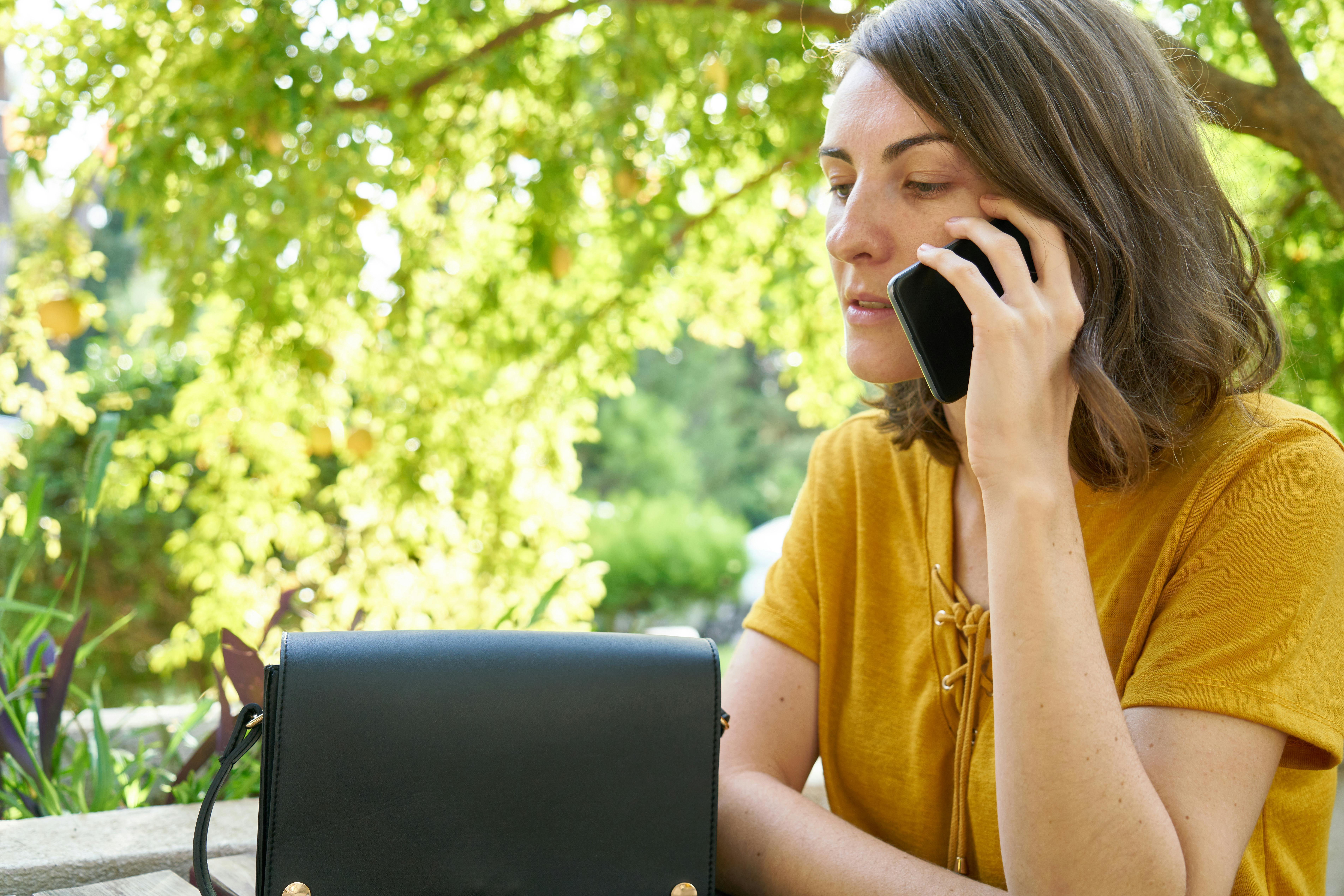 A woman on a call while outside | Source: Pexels