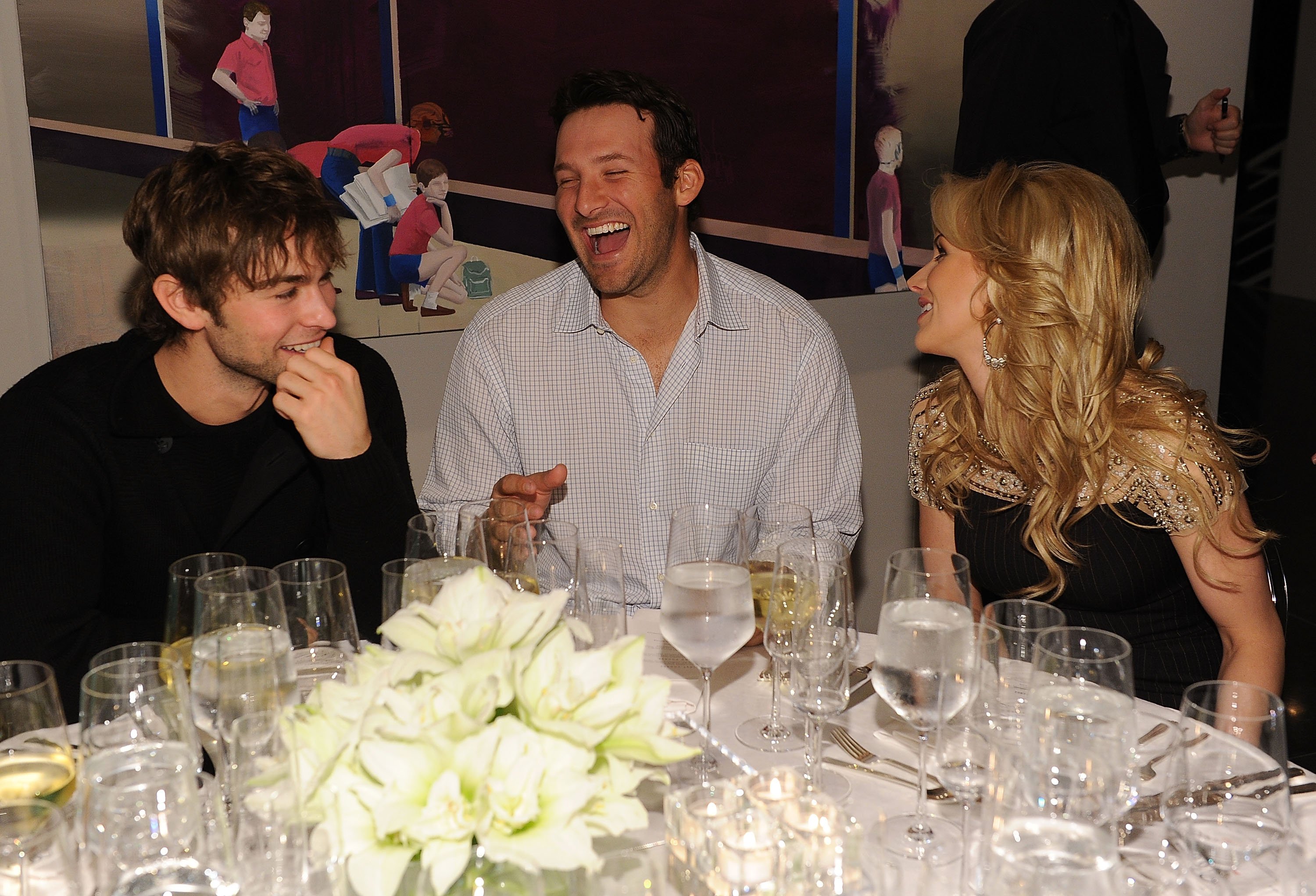 (L-R) Actor Chace Crawford, Dallas Cowboys Quarterback Tony Romo and television personality Candice Crawford attend a private dinner hosted by Audi during Super Bowl XLV Weekend at the Audi Forum Dallas on February 5, 2011 in Dallas, Texas. | Source: Getty Images 
