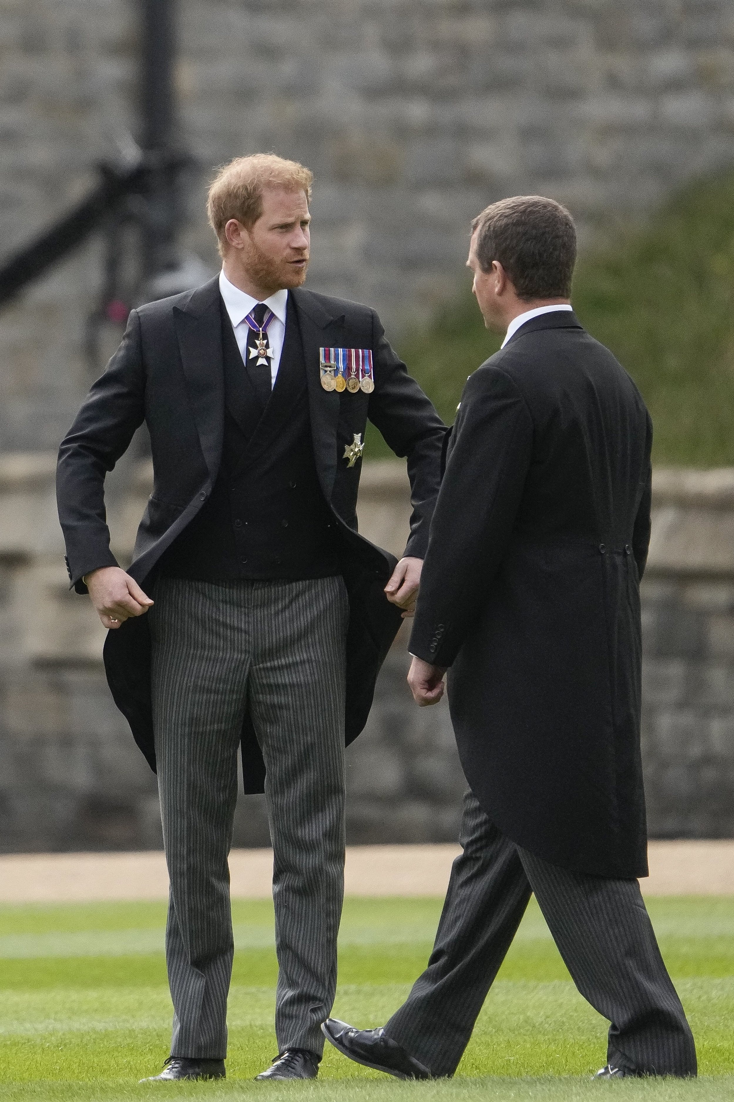 Prince Harry speaking with Peter Phillips as they arrive for the Queen Elizabeth II Committal Service at Windsor Castle on September 19, 2022, in Windsor, England | Source: Getty Images