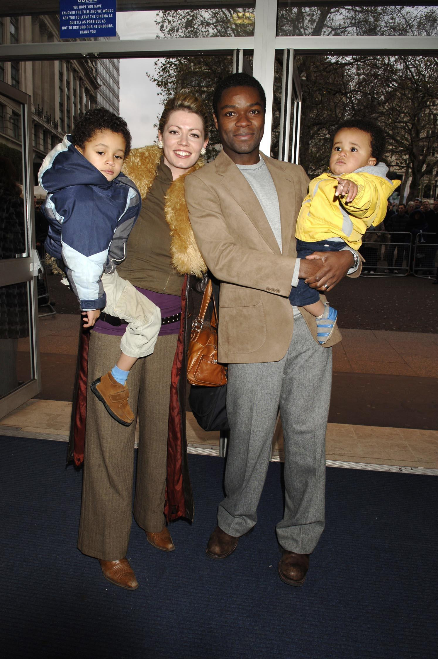 Jessica and David Oyelowo stepped out together with their young sons, Asher and Caleb, at the UK premiere of "It's A Boy" in London on November 27, 2005, offering a rare early glimpse into their growing family. The image captures the couple balancing public life and parenthood with ease, each holding a child close as they arrived for the event.