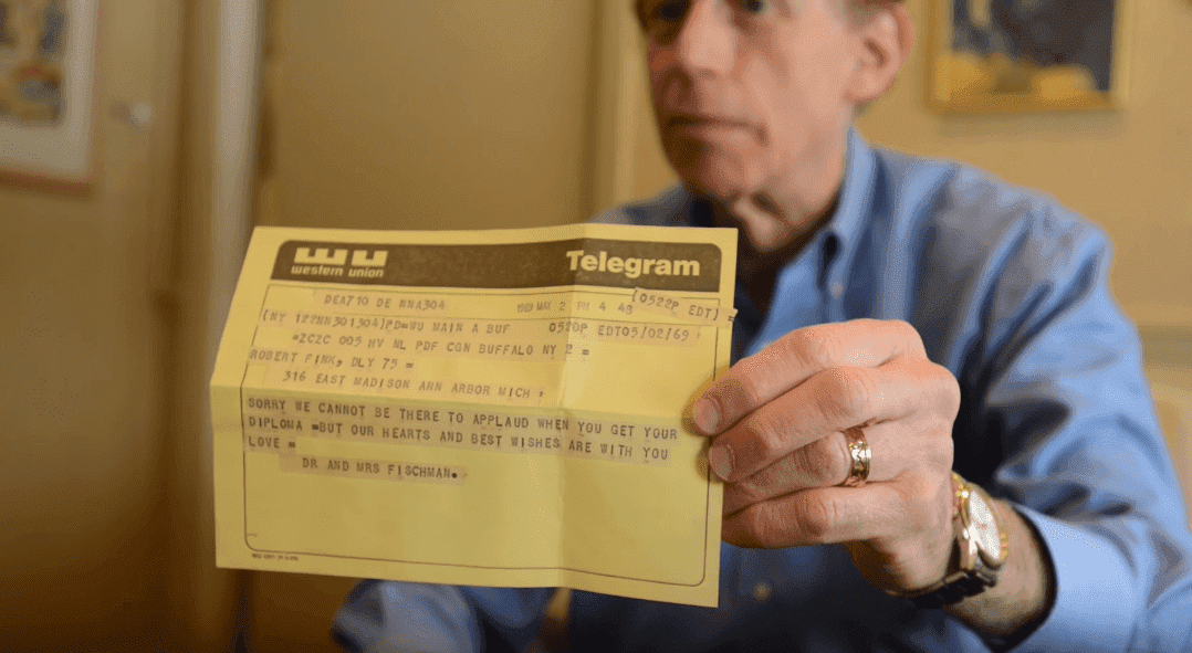 Robert Fink holding the telegram | Photo: YouTube/MLive