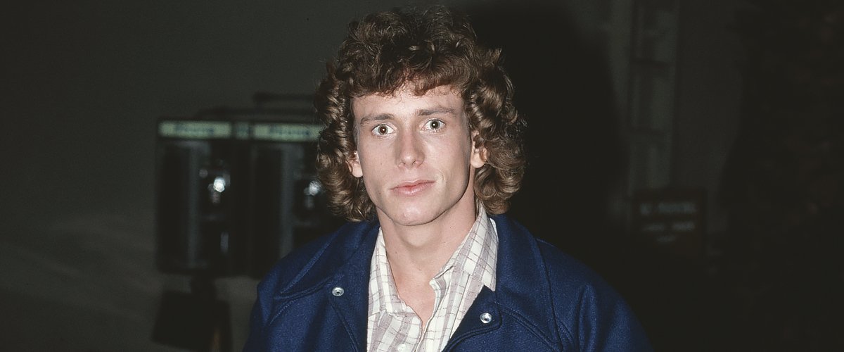 American actor Willie Aames stands with his hands in the pockets of his baseball jacket, which features the motif 'VIII's Enuf' in January 1980 | Photo: Getty Images