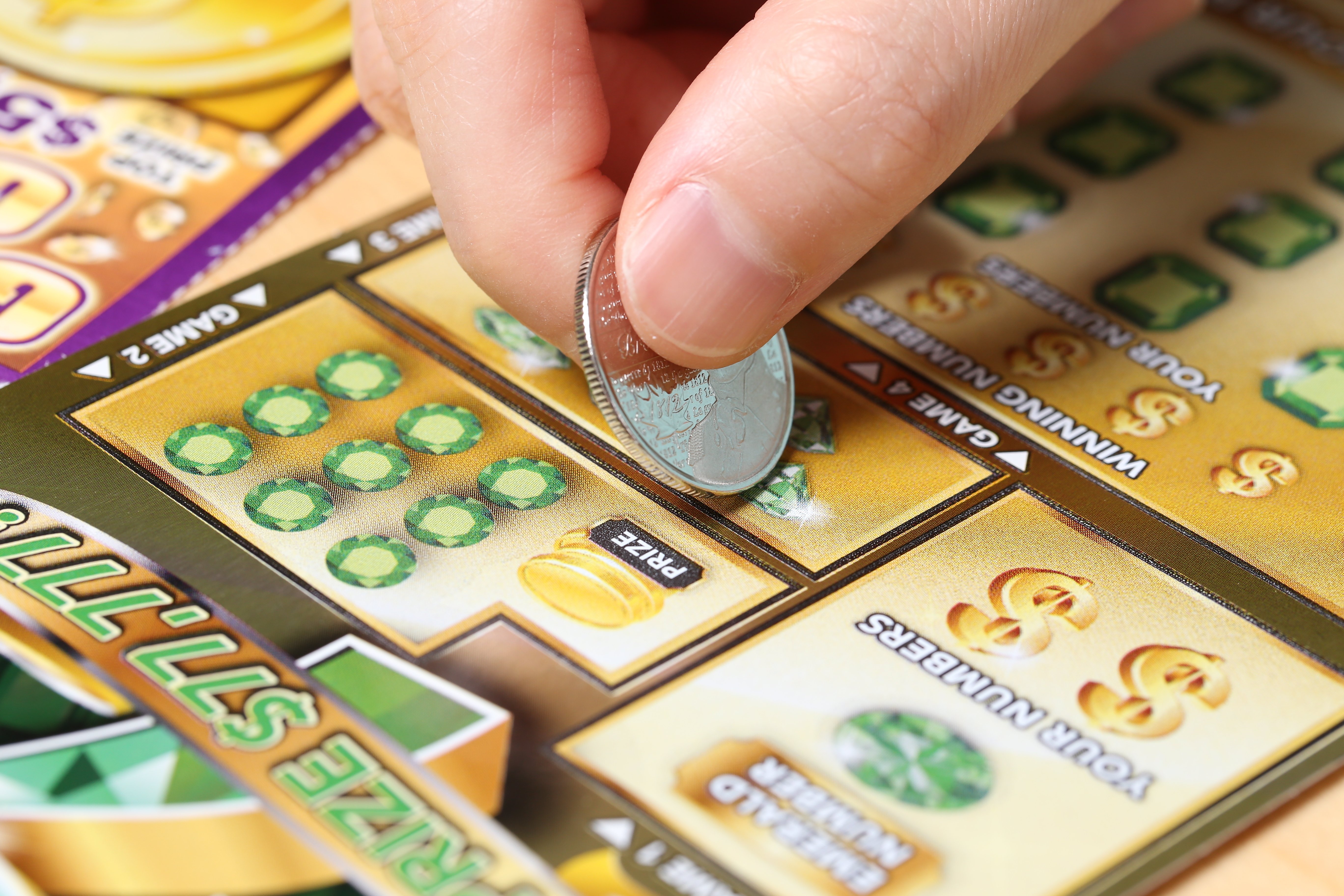 A lottery ticket being scratched | Photo: Shutterstock