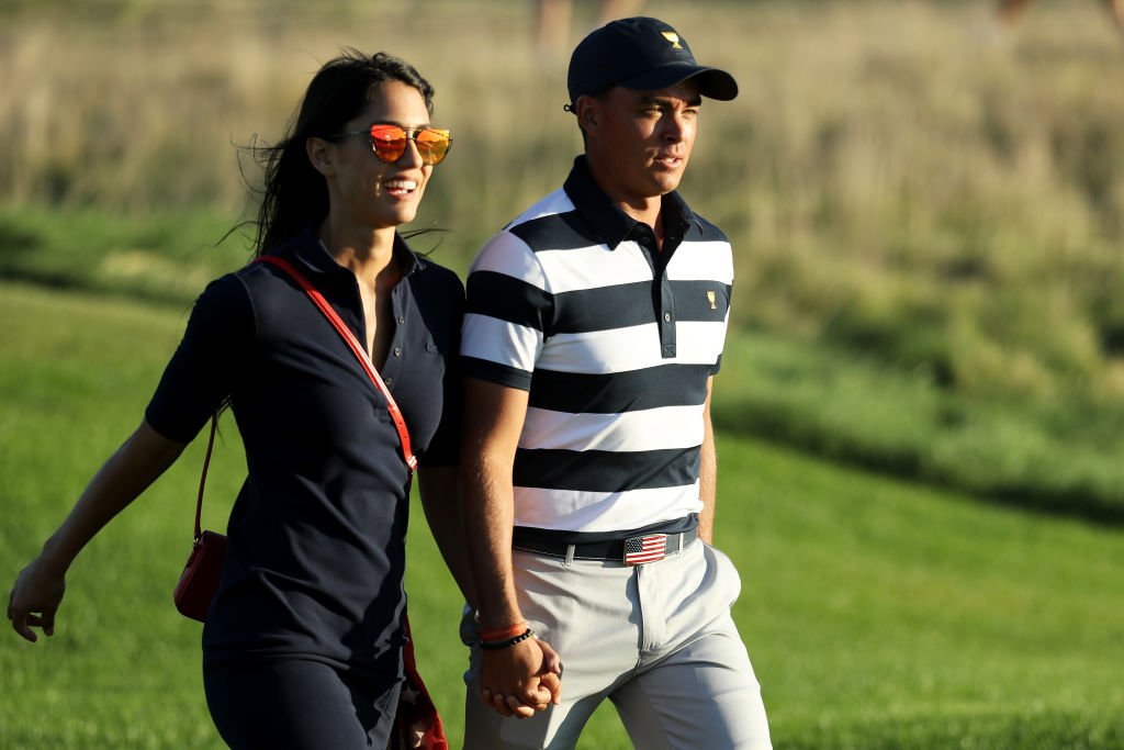 Rickie Fowler of the U.S. Team and Allison Stokke walk on the 17th hole during Thursday foursome matches of the Presidents Cup at Liberty National Golf Club on September 28, 2017 in Jersey City, New Jersey. | Source: Getty Images